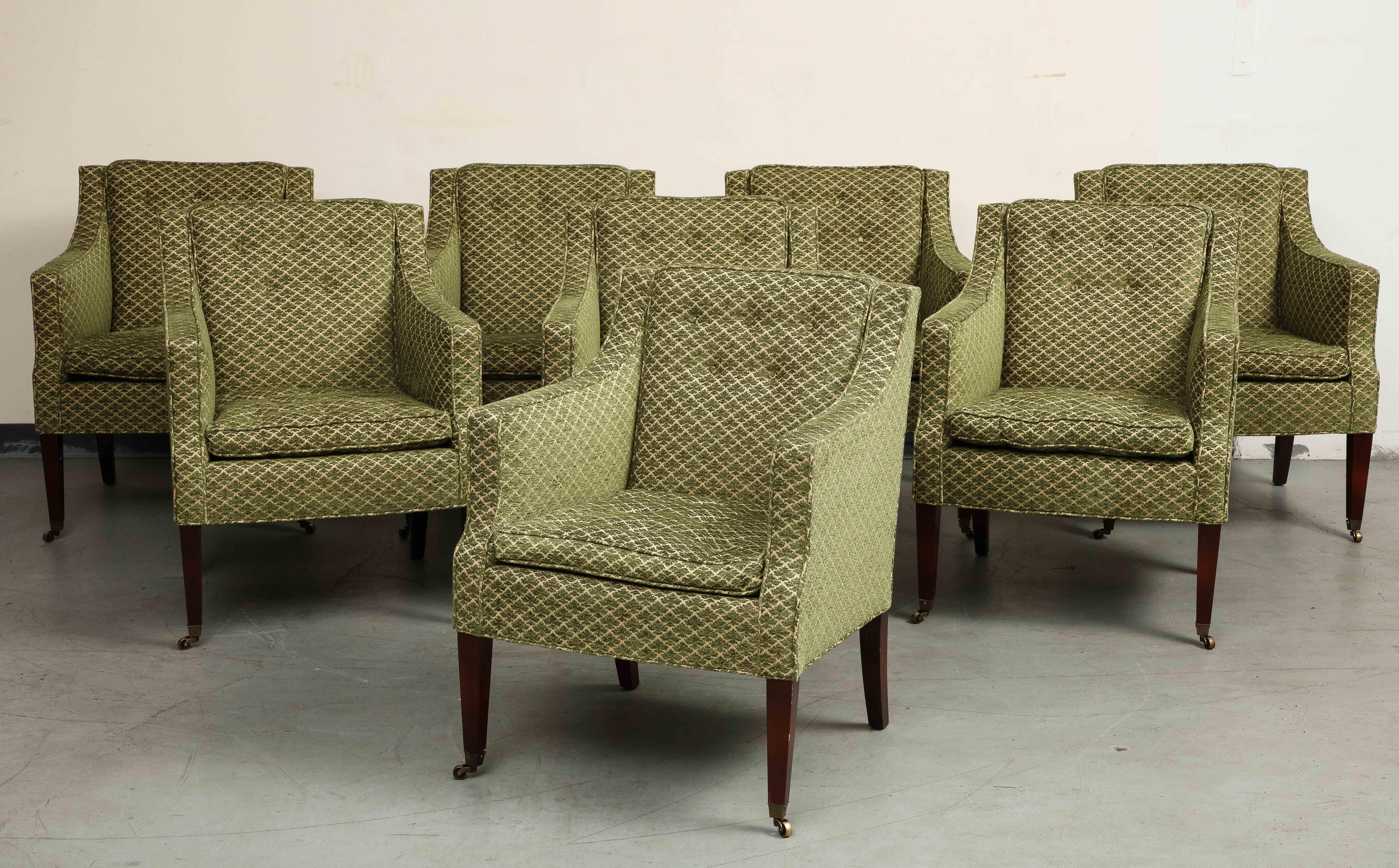 A set of eight (8) George III Late Regency style upholstered armchairs, each with square upholstered frames with down swept upholstered arms on four tapering square mahogany legs on casters. Upholstered in a deep green leaf patterned strie velours /