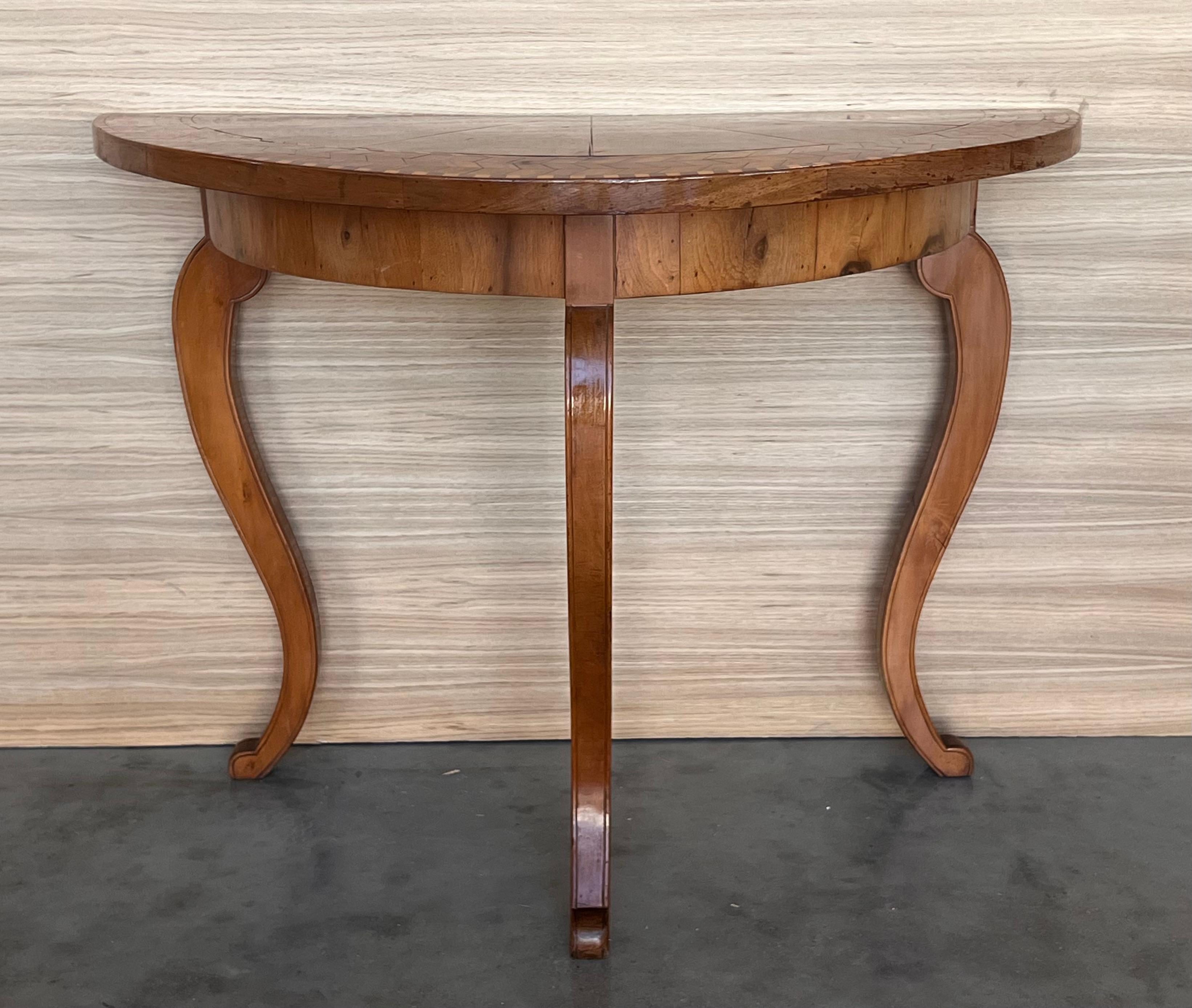 Elegant English inspired satinwood demilune console table with Fine classical swagged marquetry inlay on the top, drawer and sides, raised on tapering legs with brass caps. 