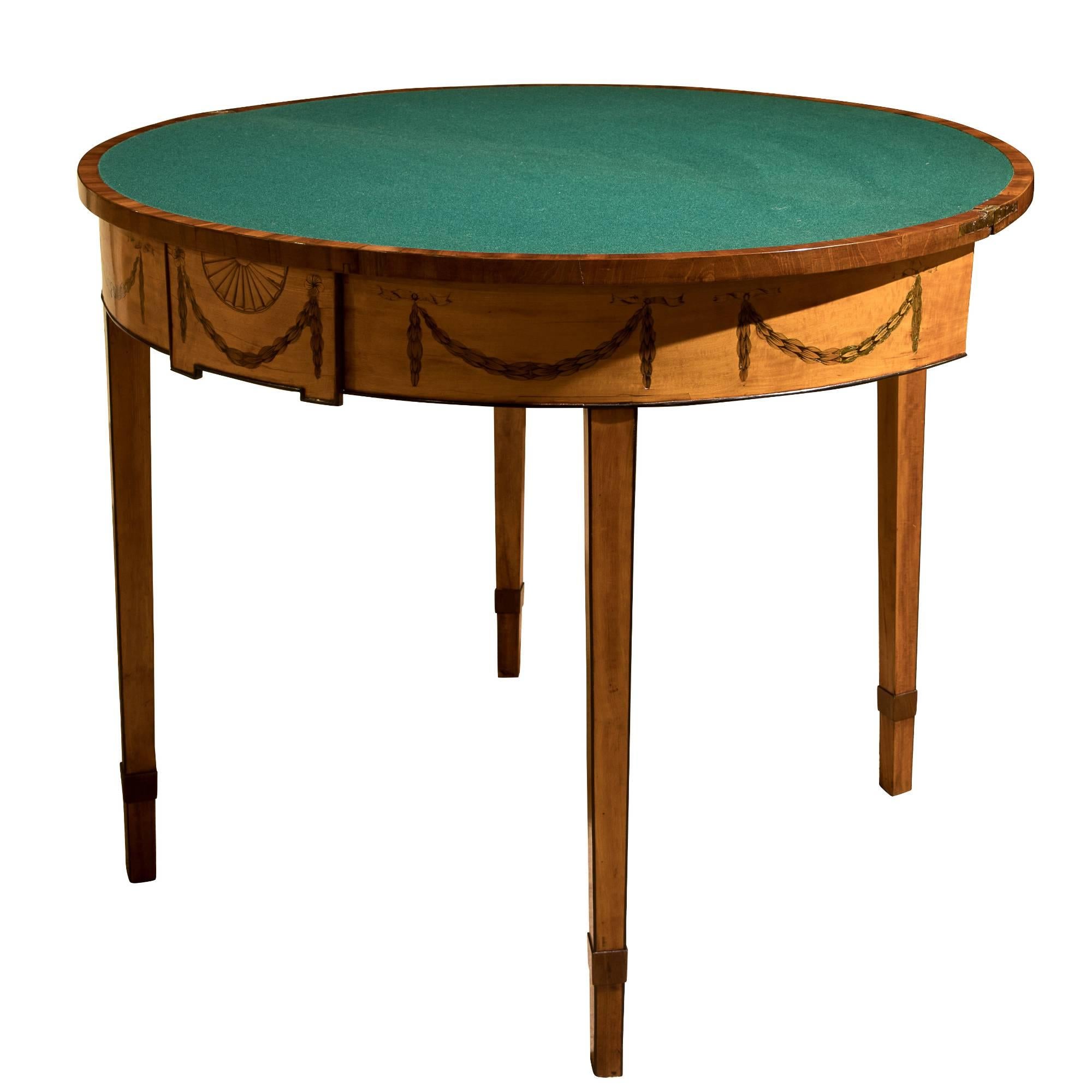 A George III satinwood demilune card table.

(with restoration).