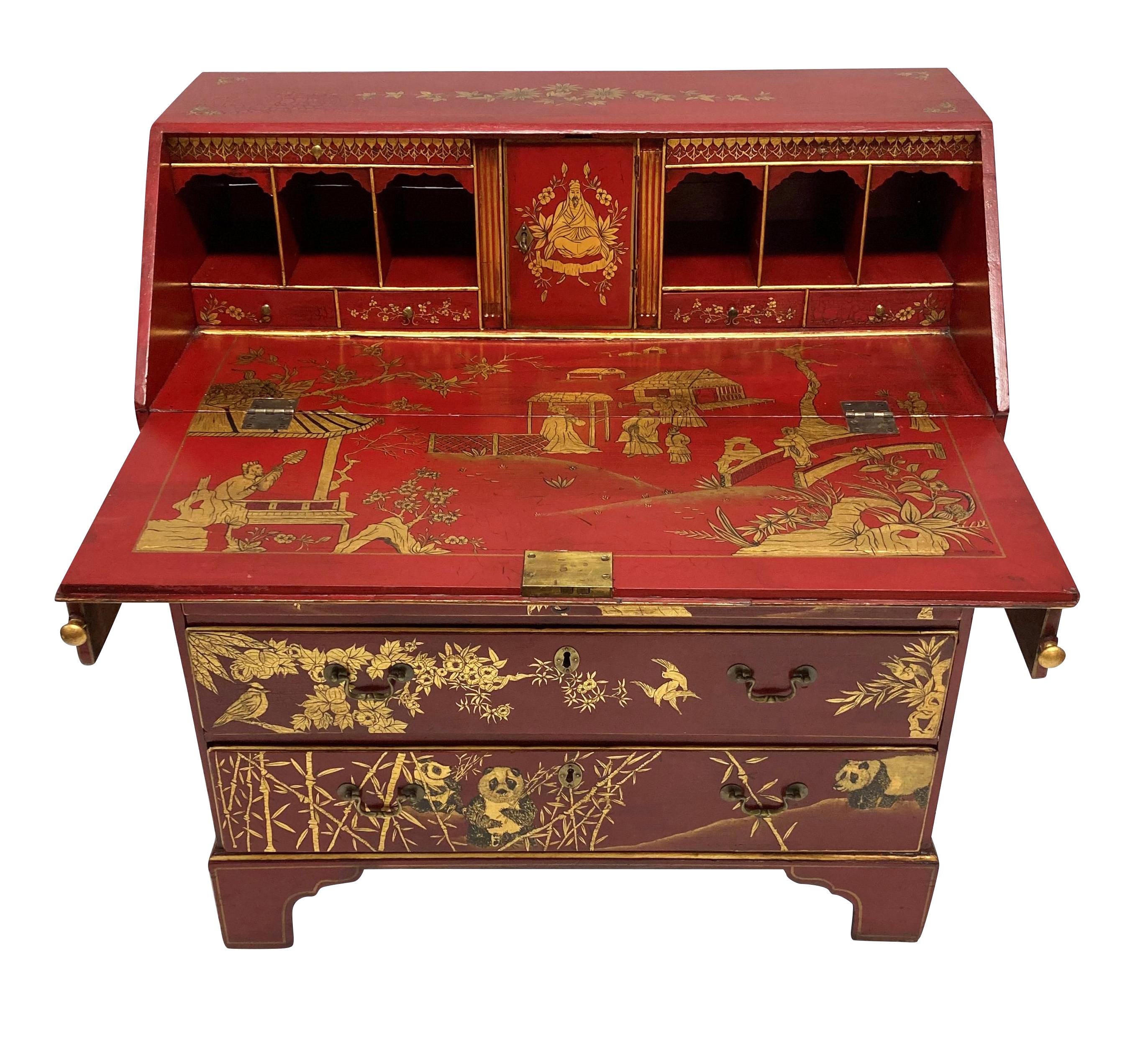 A English George III scarlet gilt-japanned desk; superbly, later decorated with rich gilt chinoiserie on a scarlet lacquered background, the fall-front opening to reveal a similarly decorated writing slide and various pigeon-holes and drawers; above