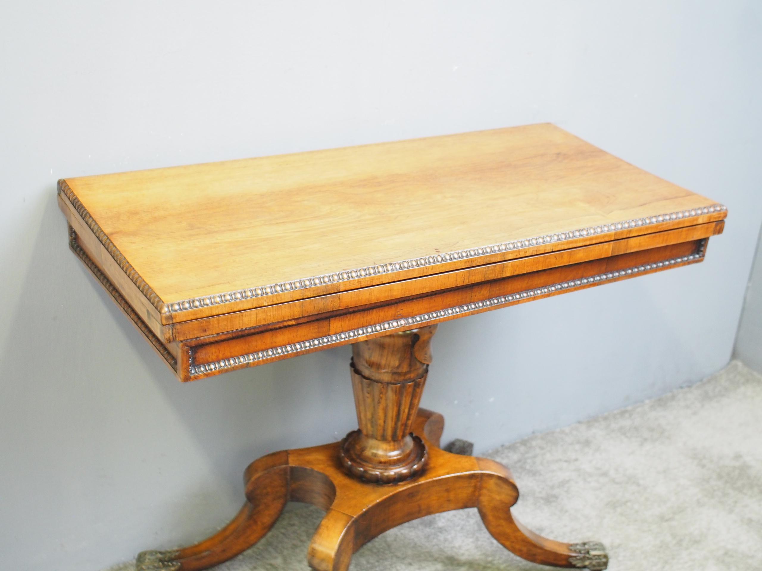 George III Scottish rosewood, fold over games table in the manner of William Trotter of Edinburgh, circa 1800. The rectangular top is in figured rosewood with a mellow color and has an egg and dart beaded fore-edge, which opens to a green