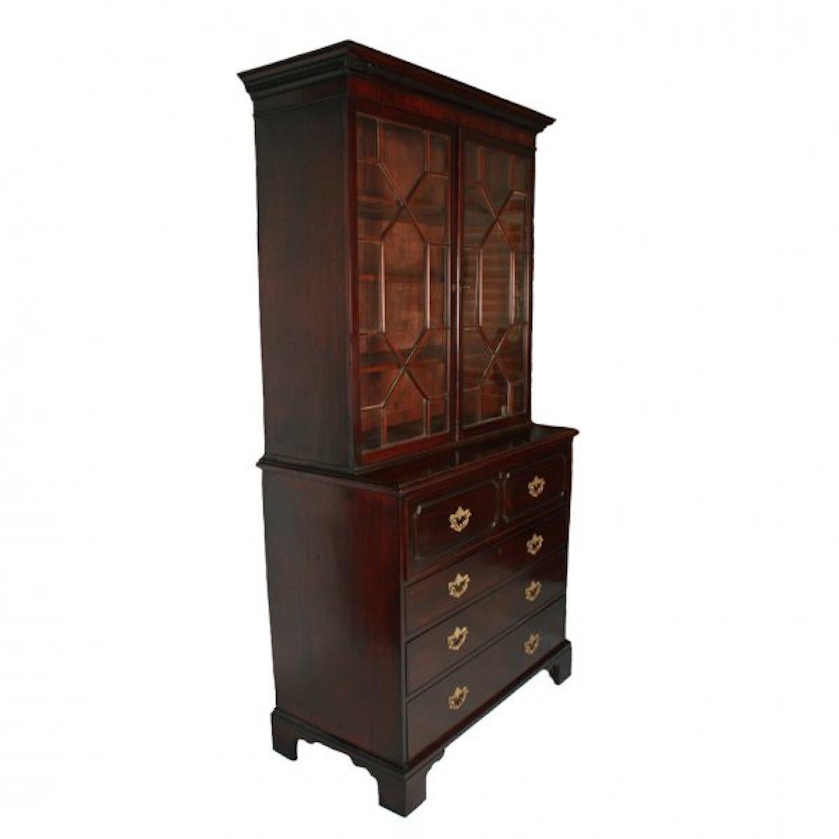 A late 18th century George III mahogany secretaire chest with a bookcase top.

The secretaire chest has a fitted top drawer with a fall front writing surface, inside there are seven mahogany drawers with rosewood cross banding and four pigeon