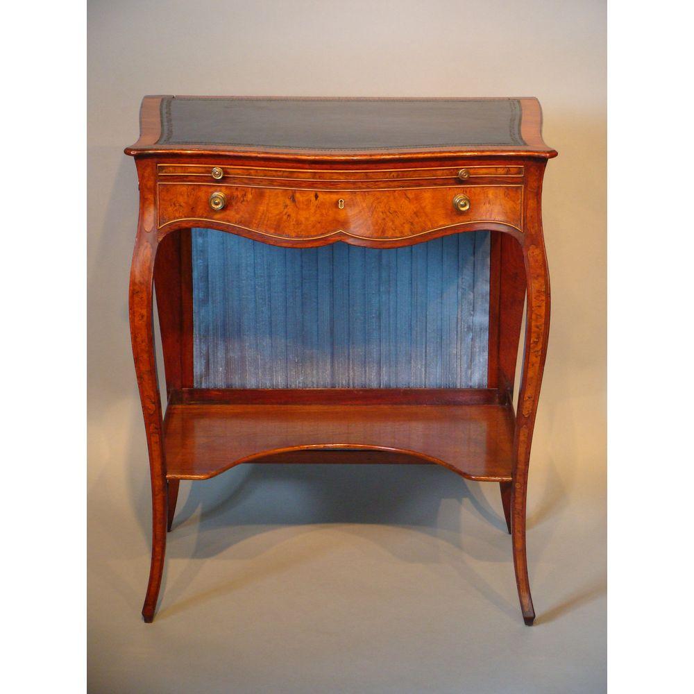 A George III period sabicu and goncalo alves serpentine writing / dressing table. In the manner of master cabinet-maker Pierre Langlois, circa 1770.
Great color, condition and surface patination.

The serpentine top inset with a blue, gilt-tooled