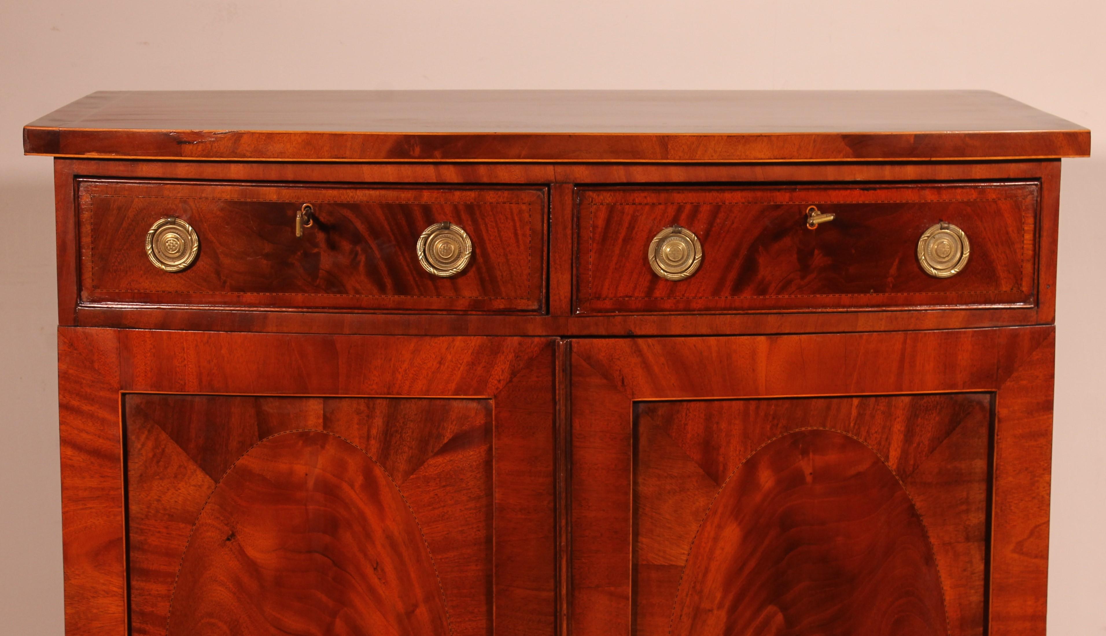 George III period buffet or side cabinet in mahogany from the end of the 18th century

very beautiful and rare bowfront sideboard our first in 10 years composed of two doors and two drawers

The front of the piece is curved which gives it a