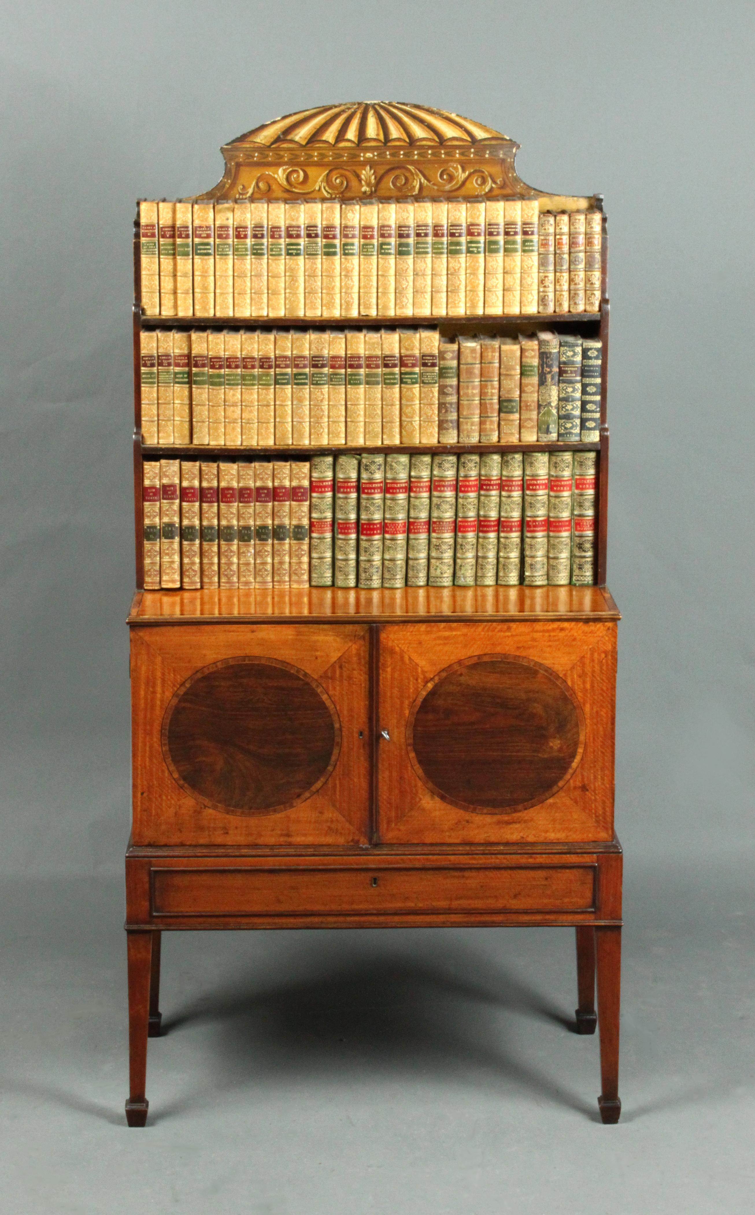 A George III Sheraton period satinwood dwarf bookcase, inlaid ovals in the doors and attractive cresting in the original paint.