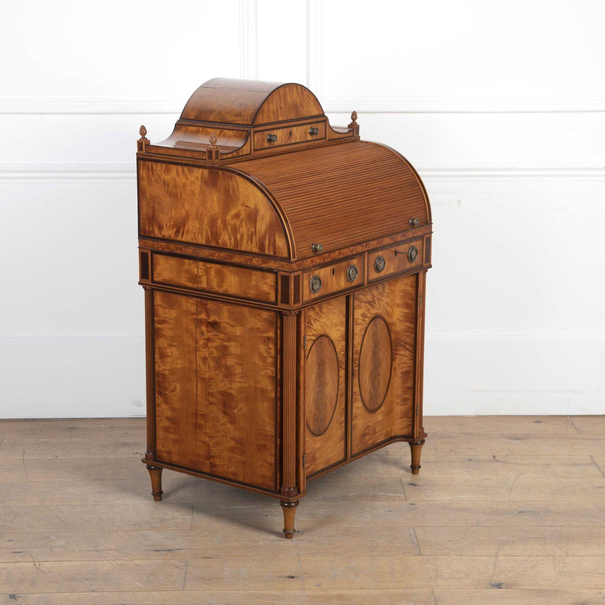 A stunning George III Sheraton Period lady's small tambour fronted desk.
Constructed from exceptional figured satinwood with rosewood crossbanding between boxwood line inlay.
The domed top housing a useful drawer with lions head pulls and each
