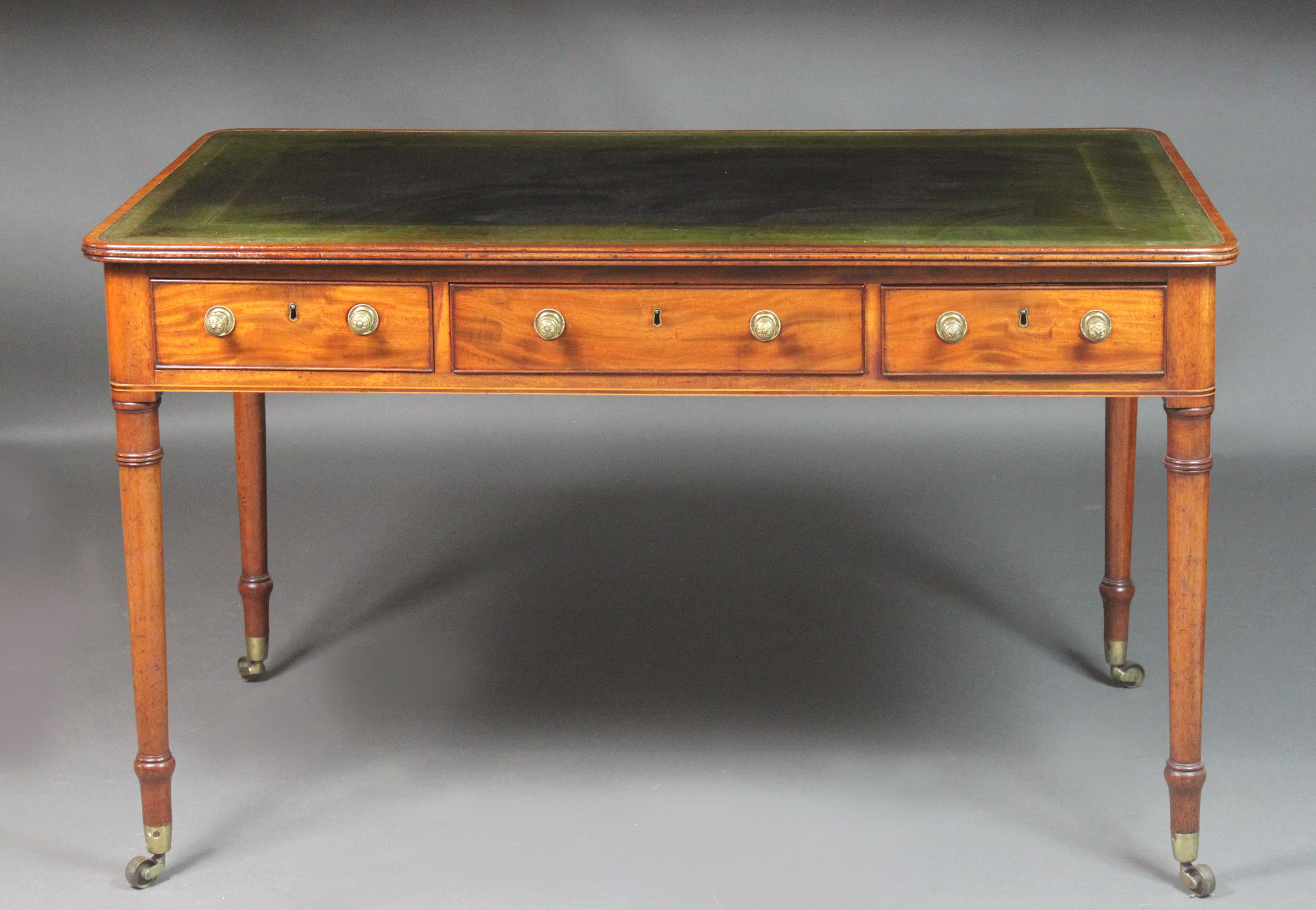 A fine George III Sheraton period partners writing table in figured mahogany with box wood stringing in the top at the edge of the leather and also in the frieze below the drawers. Elegant turned legs with Georgian castors and good quality brass