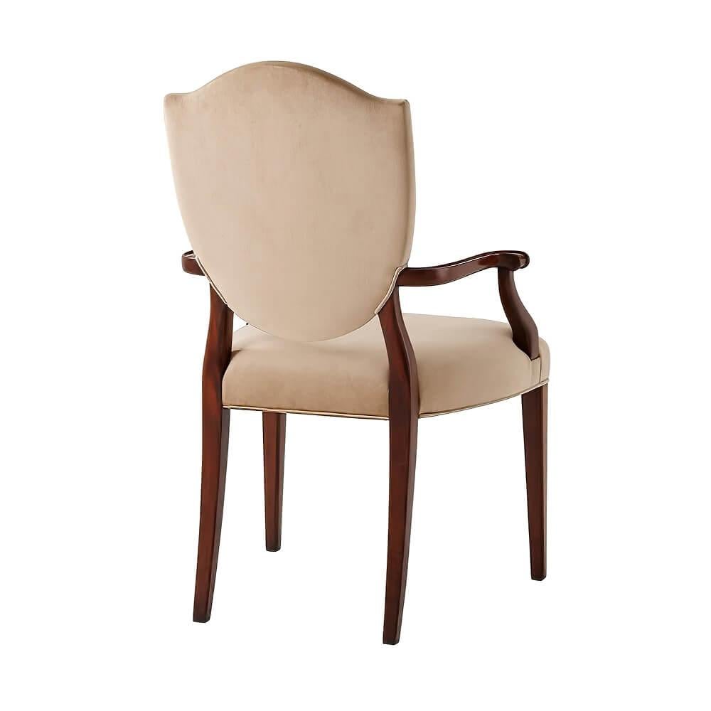 A Hepplewhite style shield back armchair, the upholstered back with flame mahogany veneered back Supports and scroll arms with rosette terminals, the upholstered seat on square tapering legs with satinwood faux fluted inlay.
Dimensions: 23.75