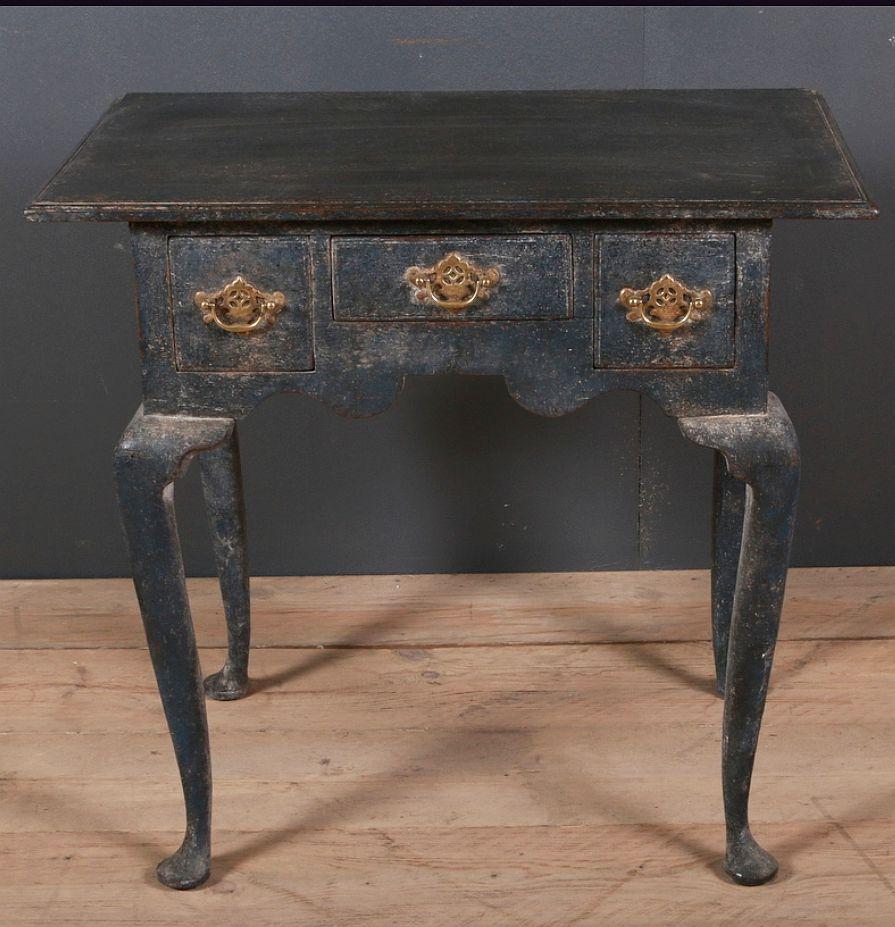 A dark blue painted George III side table, 'low-boy' with gilded brass handles, England, circa 1800.