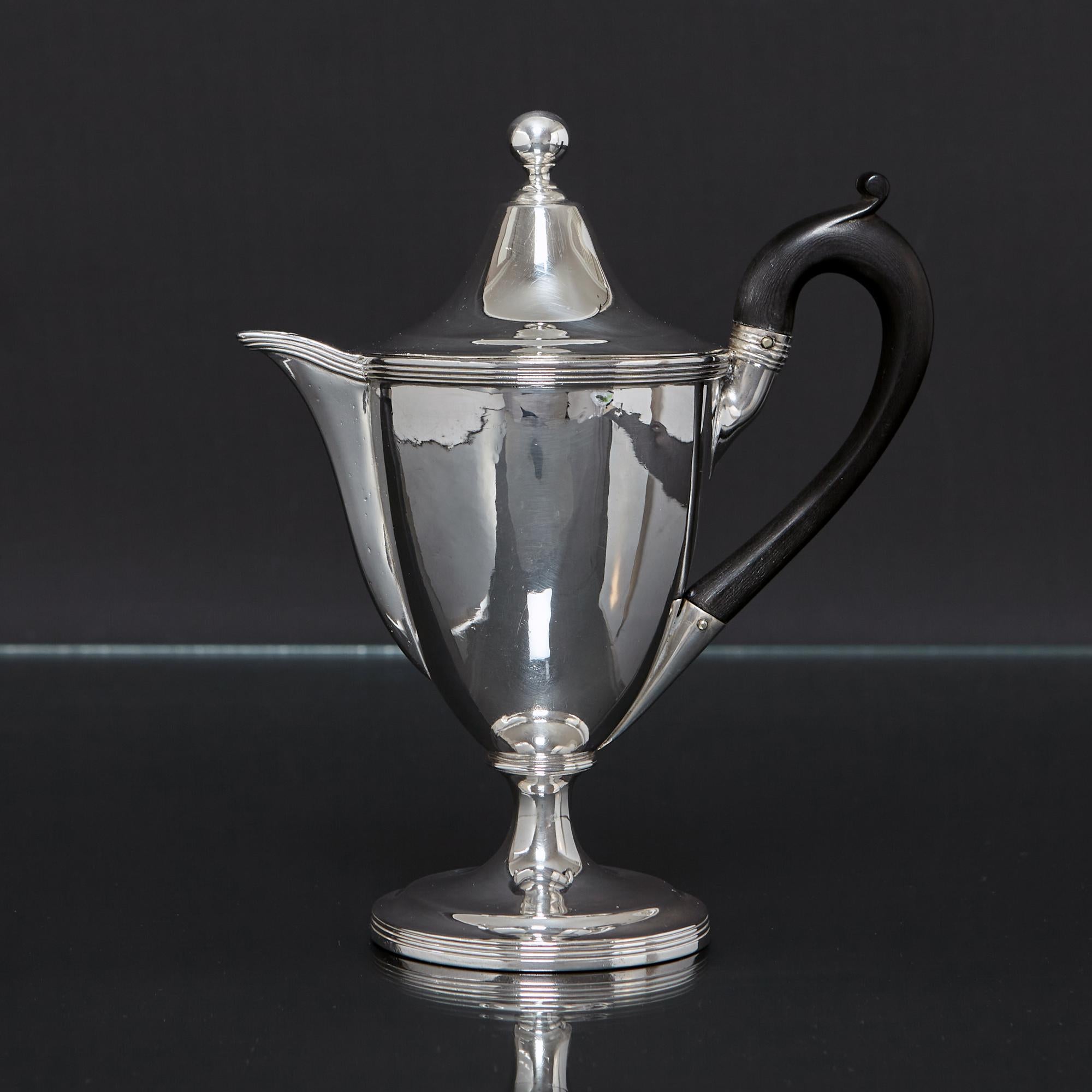 This is a lovely example and rare configuration of the heated silver gravy jug known as an argyle.  This antique silver argyle is lidded and fitted with a hot water panel in the base to keep the gravy hot. Boiling water is poured in through the