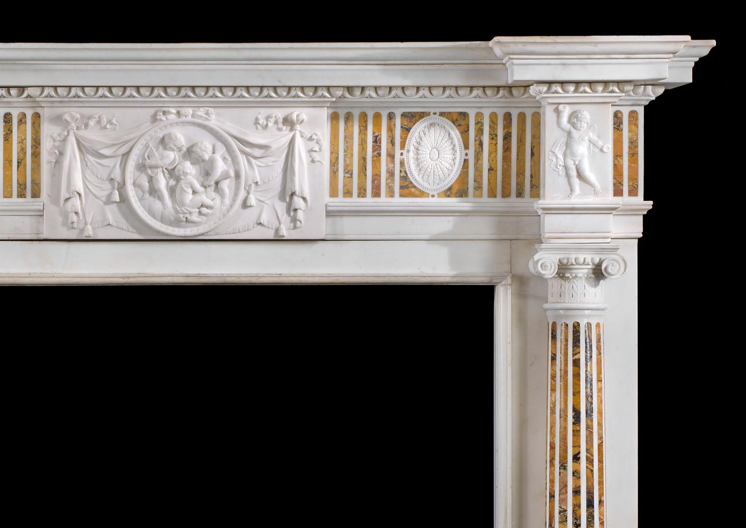 A fine George III chimneypiece in Statuary and Siena marble. The inverted breakfront shelf sits above a boldly carved egg and dart undershelf, resting over the faux fluted frieze inlaid with fine Siena Marble and studded with two oval paterae.
The