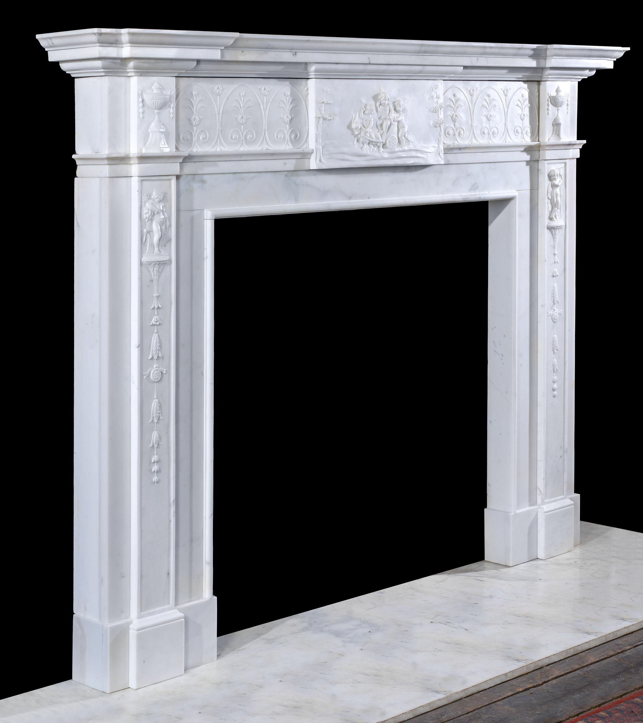 A fine eighteenth century George III chimneypiece in statuary marble. The solid reverse breakfront shelf sits above a frieze which is delicately carved with a stylised foliate design. This is centred by a tablet depicting a putto imitating Bacchus