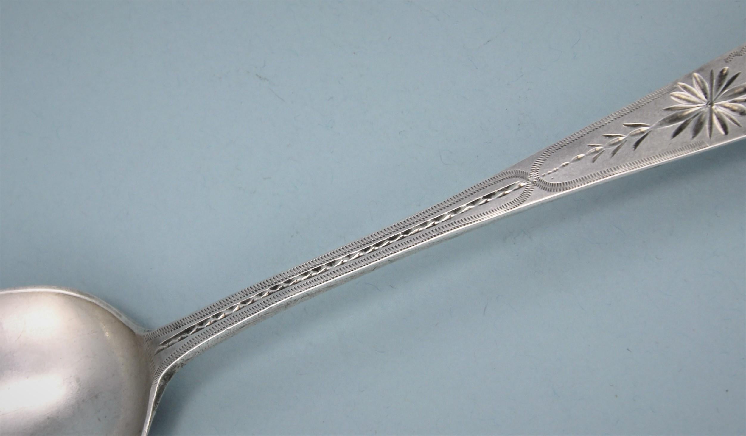Very attractive George III sterling silver bright cut table spoon.
Maker: Richard Ferris. Exeter, 1794. 

The front of the stem is engraved with typically West Country bright cut engraving. The top of the stem has a bright cut escutcheon