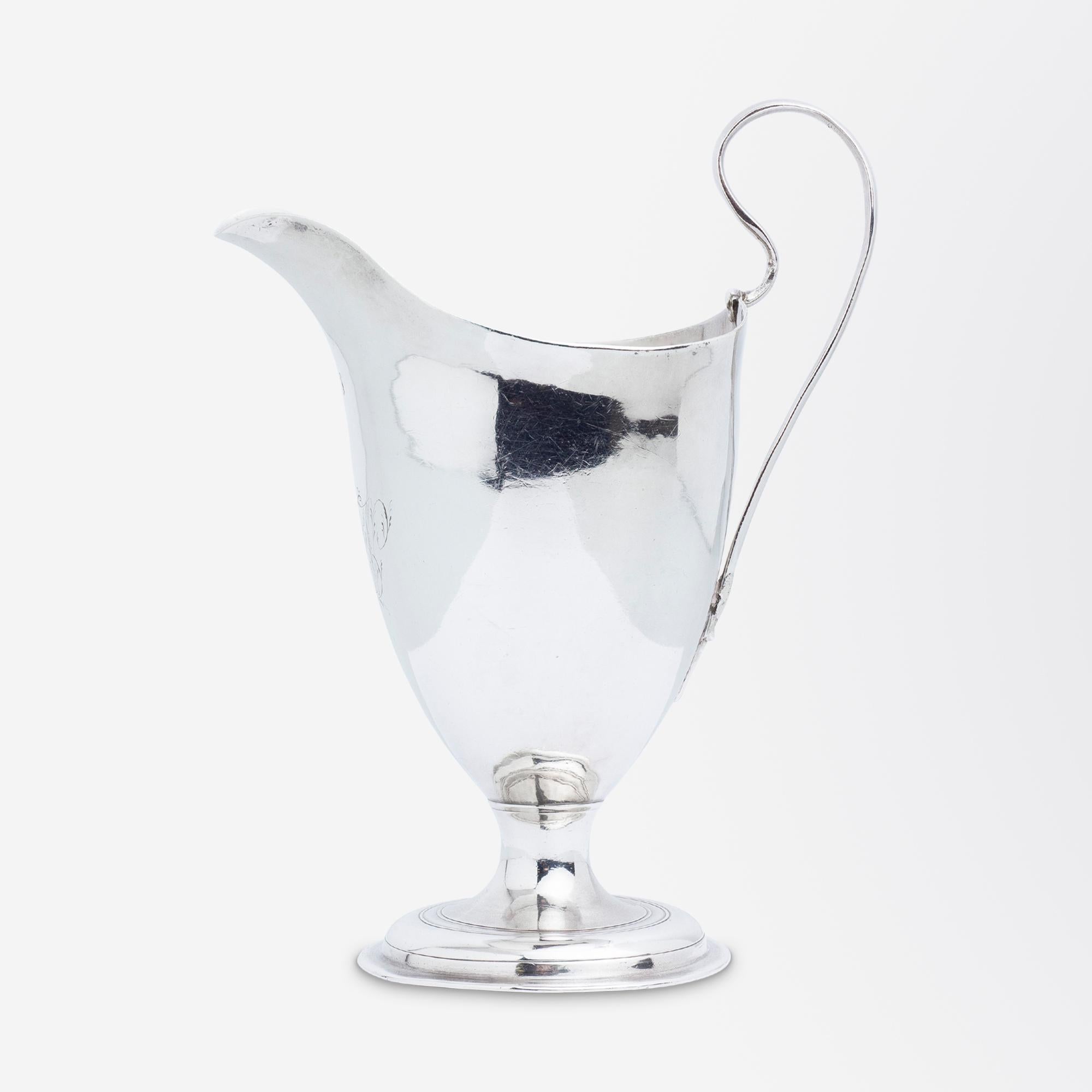 A small, George III period, sterling silver creamer by London silversmith Robert Hennel I, with period monogram. The creamer features an intricate monogram under the lip which is likely an entwined 'AW' and is most probably from the date of