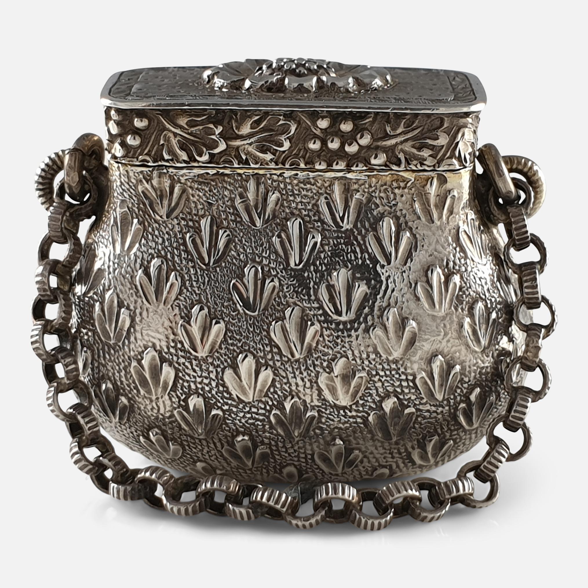 A George III sterling silver Vinaigrette by the silversmith Lawrence & Co, Birmingham, circa 1815. The Vinaigrette is of novelty bag form, with textured foliate motifs on a matted background, the cover with a grapevine border and oval shaped foliate