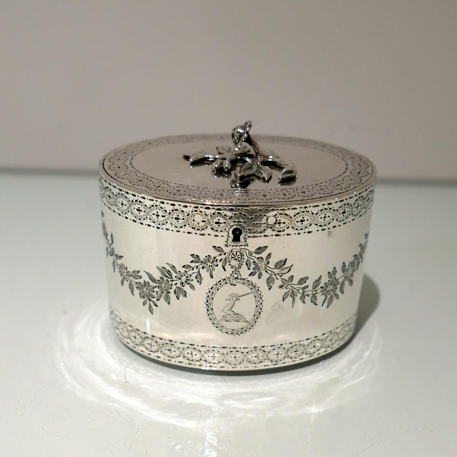 A delightful 18th century oval Georgian tea caddy decorated with upper and lower galleried bands of sumptuous bright cut engraving. The centre front has a beautiful contemporary crest for importance which is then highlighted with stylish floral