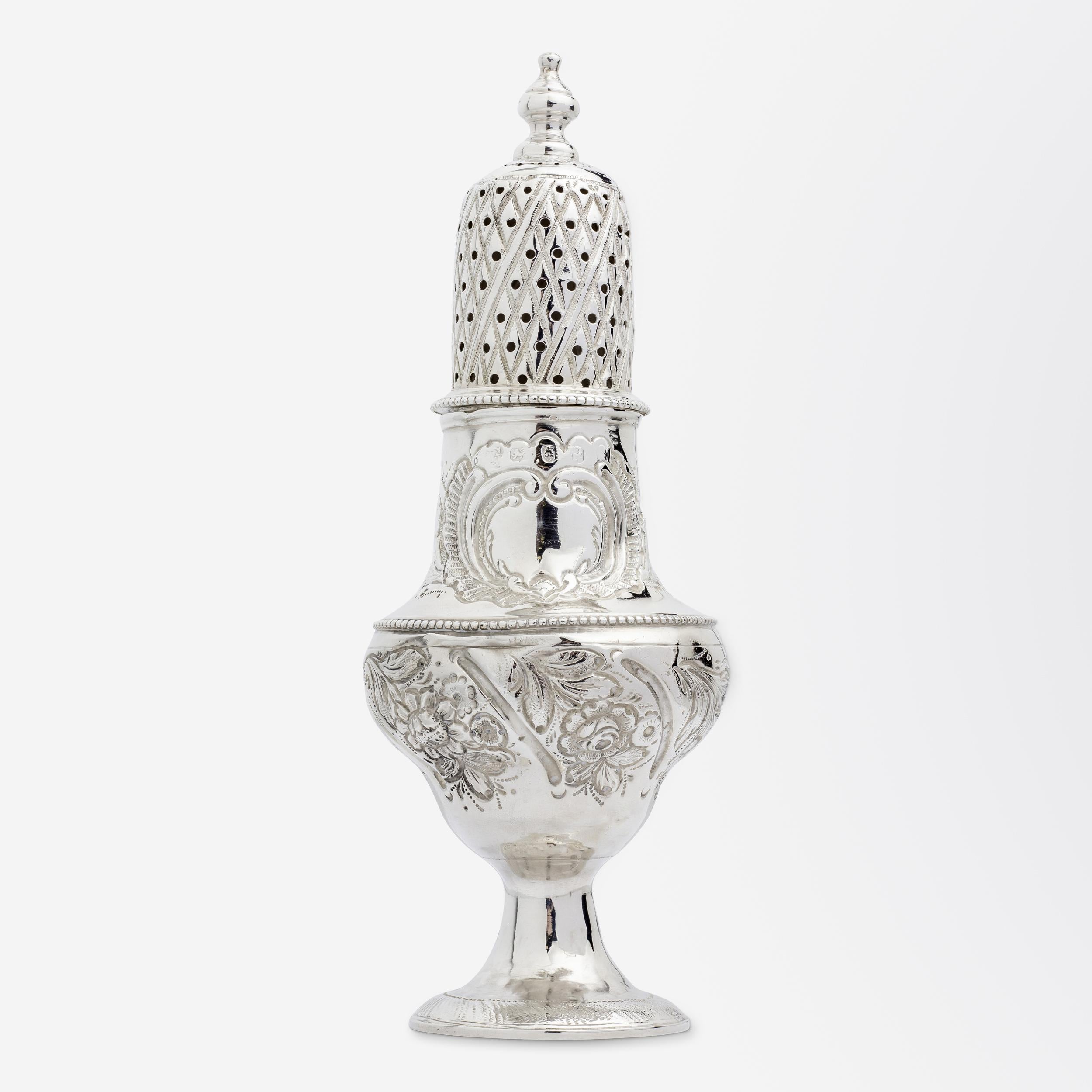 A rare George III period sterling silver sugar shaker with floral repousse decor by members of the famed English silversmithing family, The Batemans. The ornate sugar shaker has crisp marks to the lid, and rubbed marks to the base both for Peter &