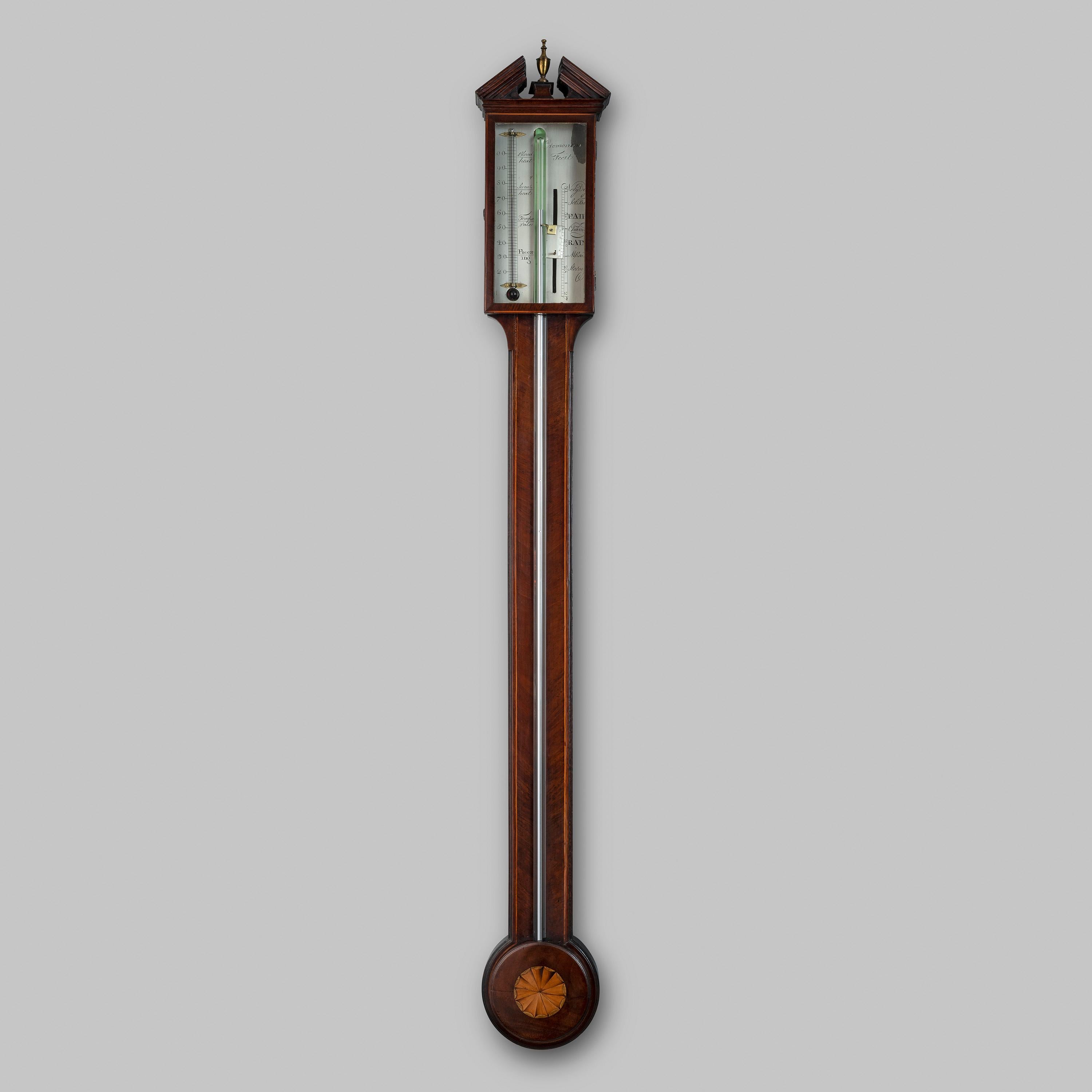 A fine and well-proportioned early 19th century figured mahogany barometer signed ‘Cremonino, Fecit.’ 

This barometer has a broken arch pediment above a flush-glass door, enclosing an engraved silvered register plate and thermometer. 

The mahogany