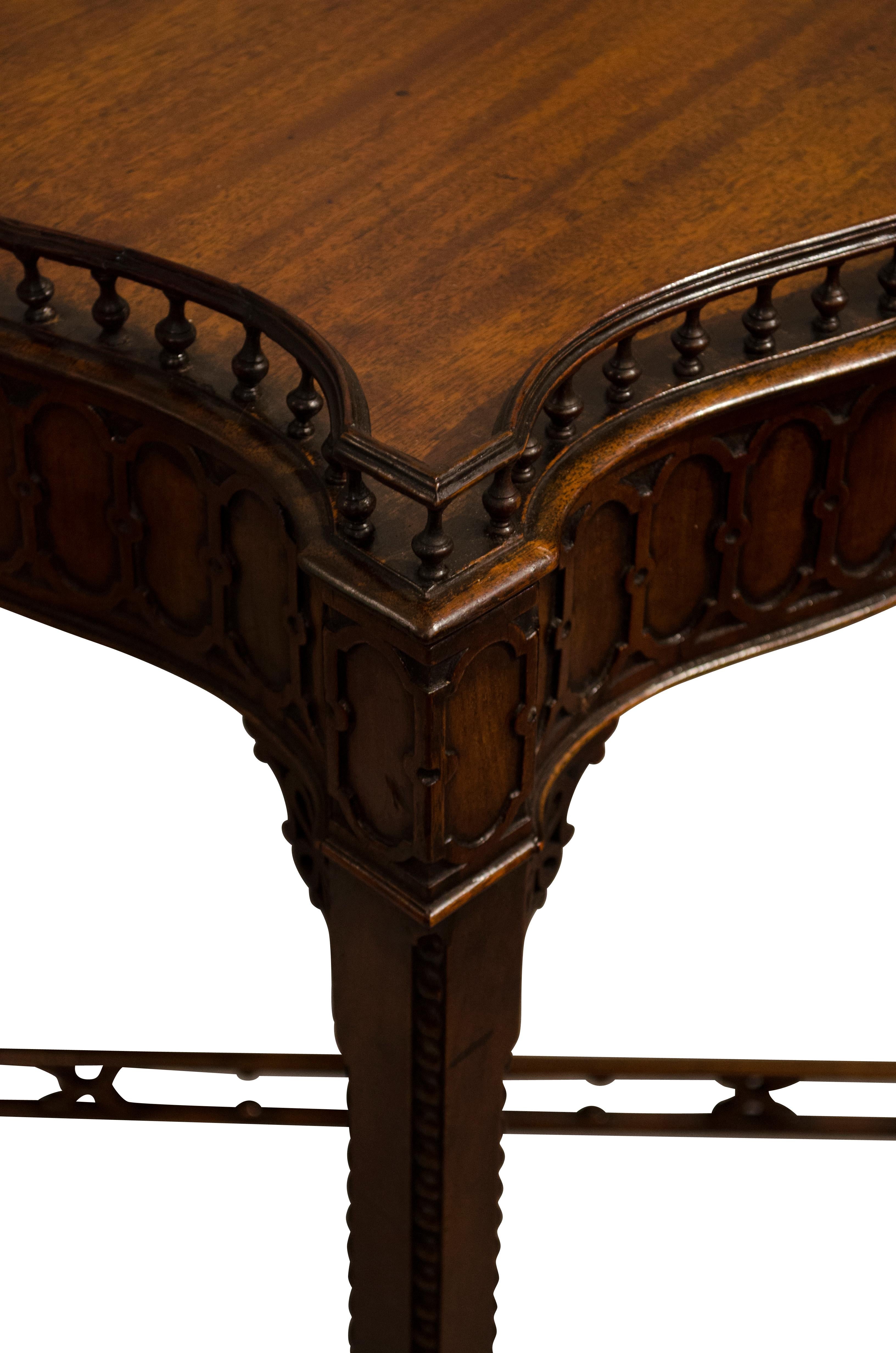 George III style 19th century serpentine sided mahogany table with spindled gallery top,
circa 1890.