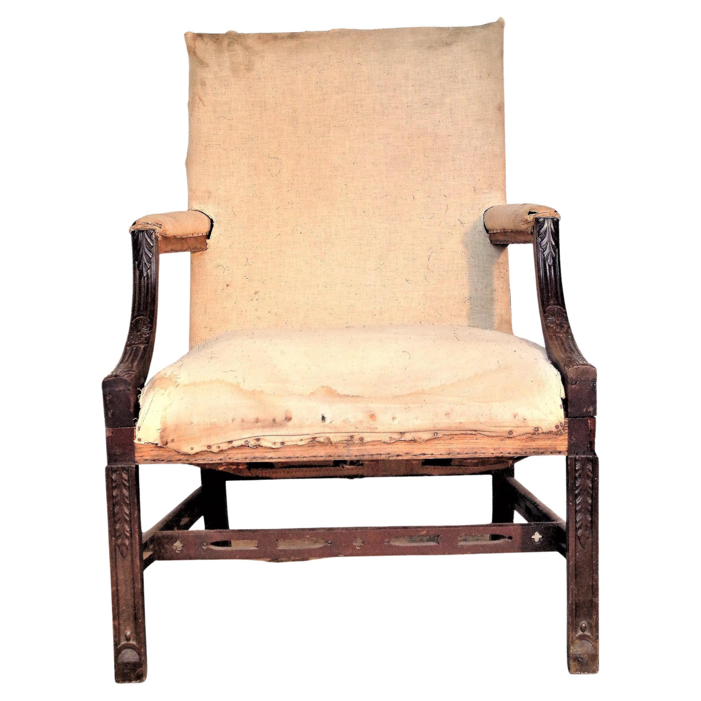 Antique George III style lolling chair with finely hand carved details on front arms, legs and stretchers. Chair is in all original deconstructed condition, showing the old muslin / canvas webbing / horsehair stuffing and framework. Most likely