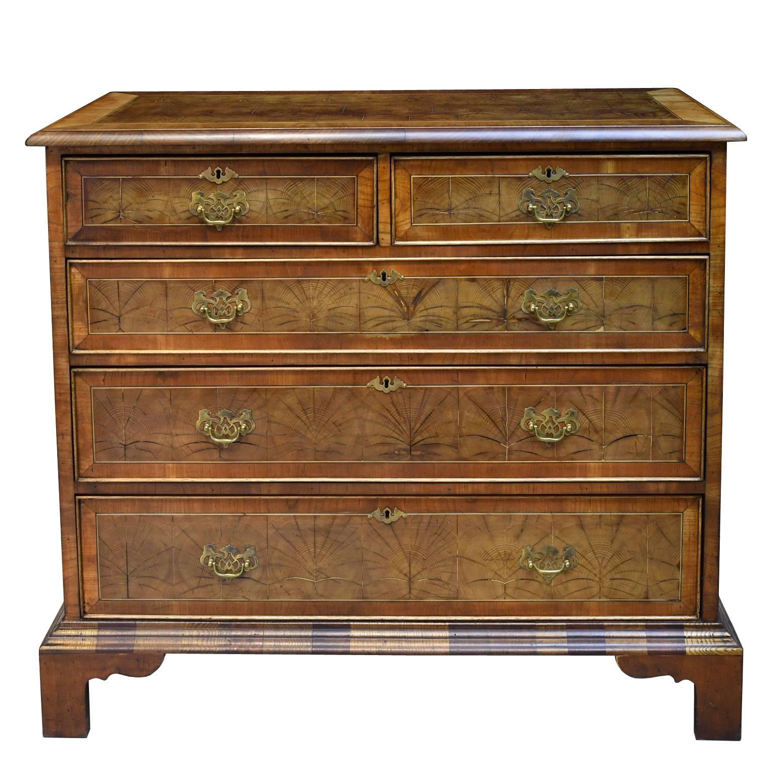 This lovely and functional chest is like the story of Eliza Doolittle in My Fair Lady since she has been made more sophisticated by several additions. Originally an antique pine chest of drawers, it has been clad with a beautiful, thick yew-wood
