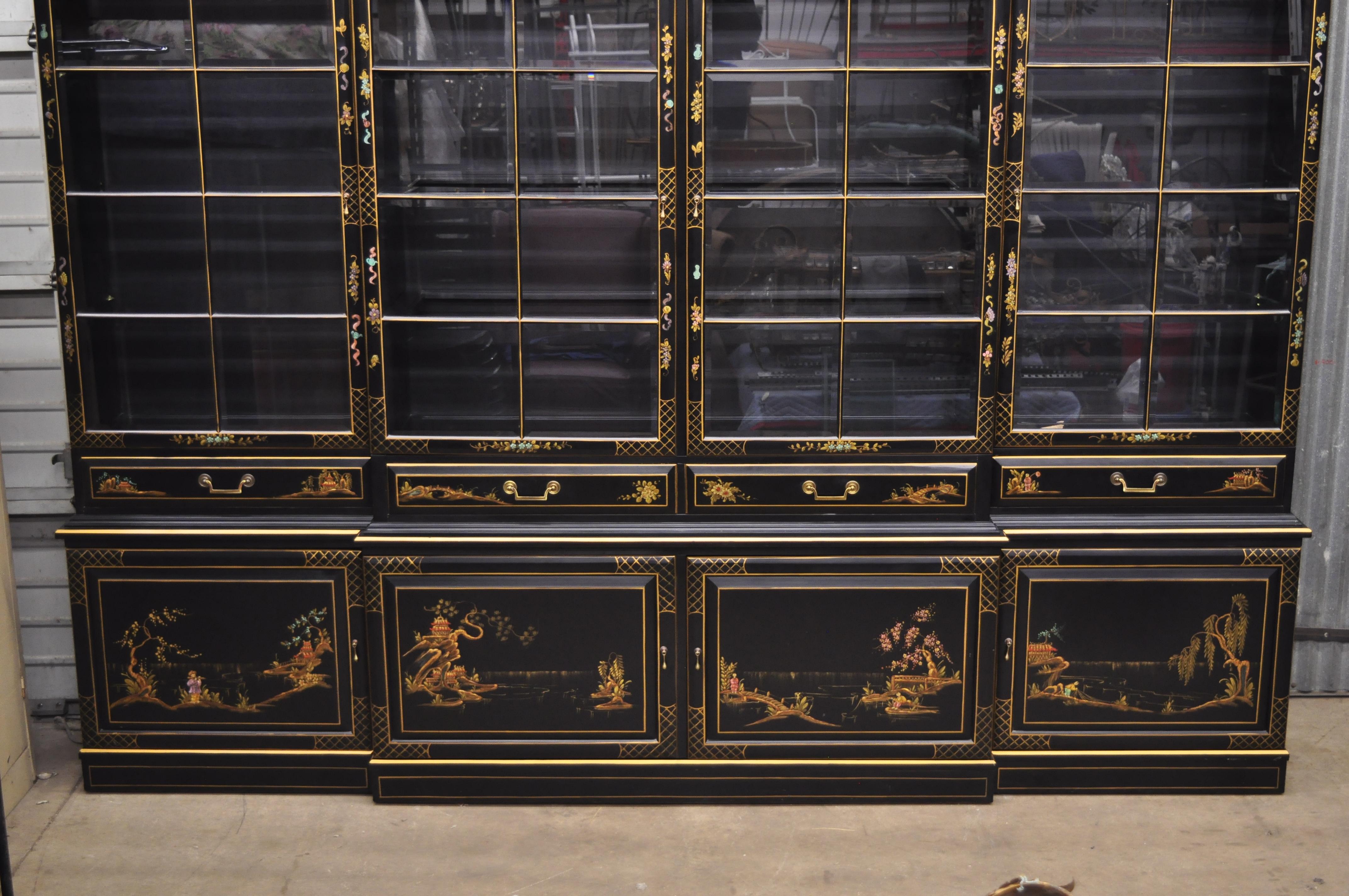 George III style chinoiserie decorated black Japanned large breakfront bookcase. Item features hand painted Asian scenes, individual panes of beveled glass to doors, fall front desk with black leather surface, hand painted details to sides, 9 upper