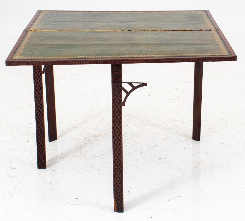 George III Style chinoiserie gateleg games table, in the manner of similar models from Thomas Chipplendale, the rectangular hinged mahogany top above an apron with hidden gateleg and square legs all decorated with Chinese-style fretwork. 29