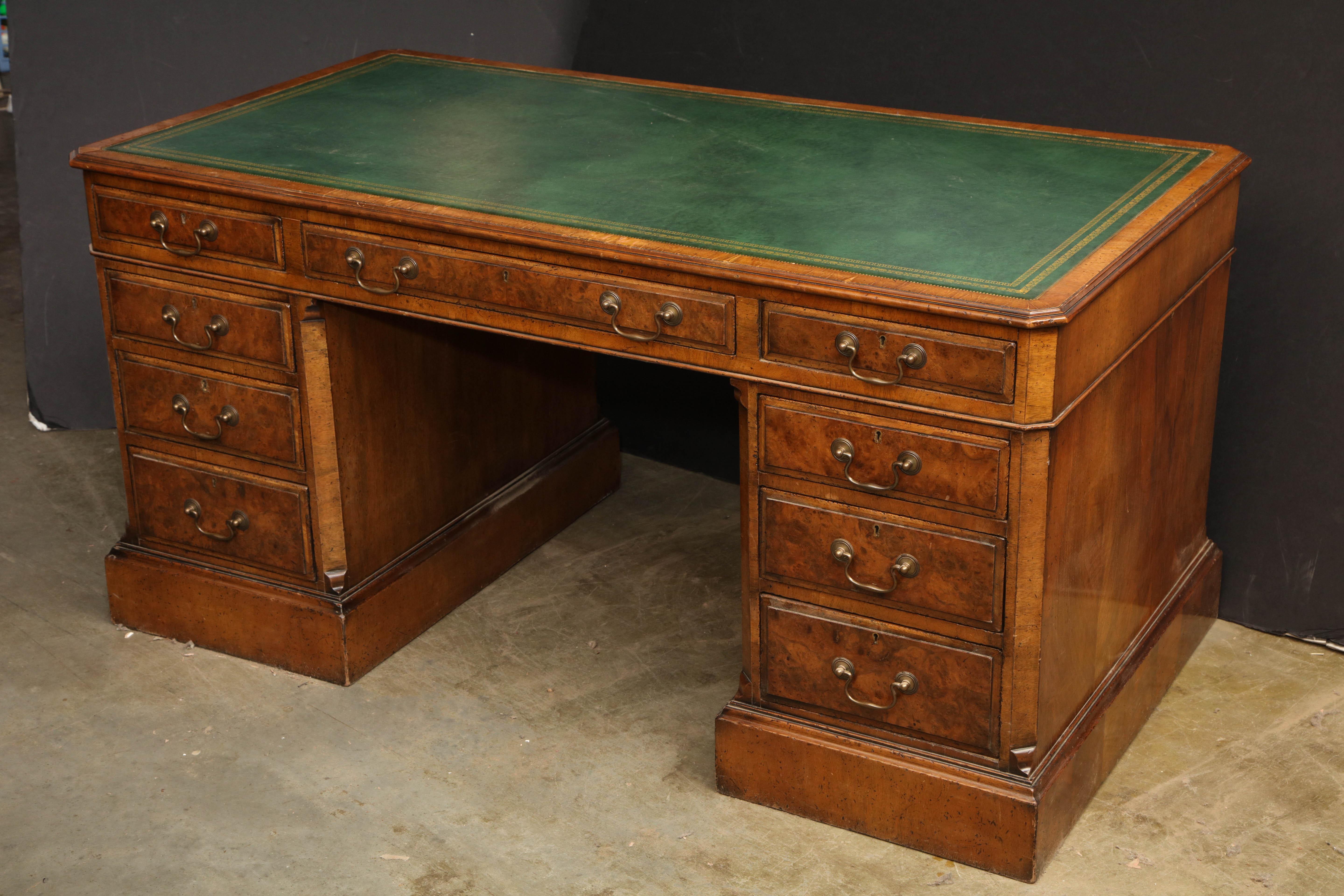 George III style walnut three part leather top pedestal desk.