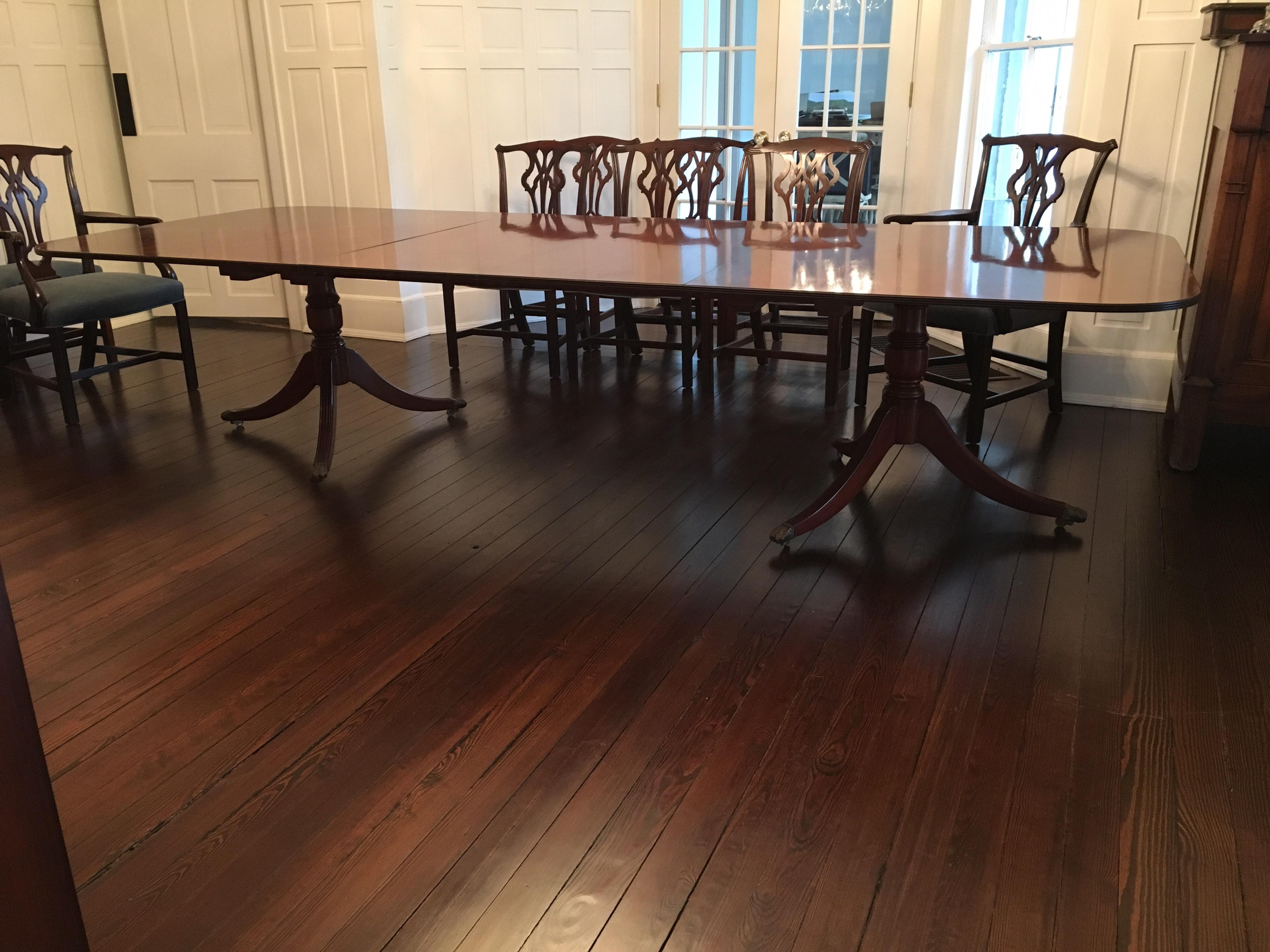 A rectangular mahogany George III style two pedestal dining table, comfortably seating twelve with both its 22