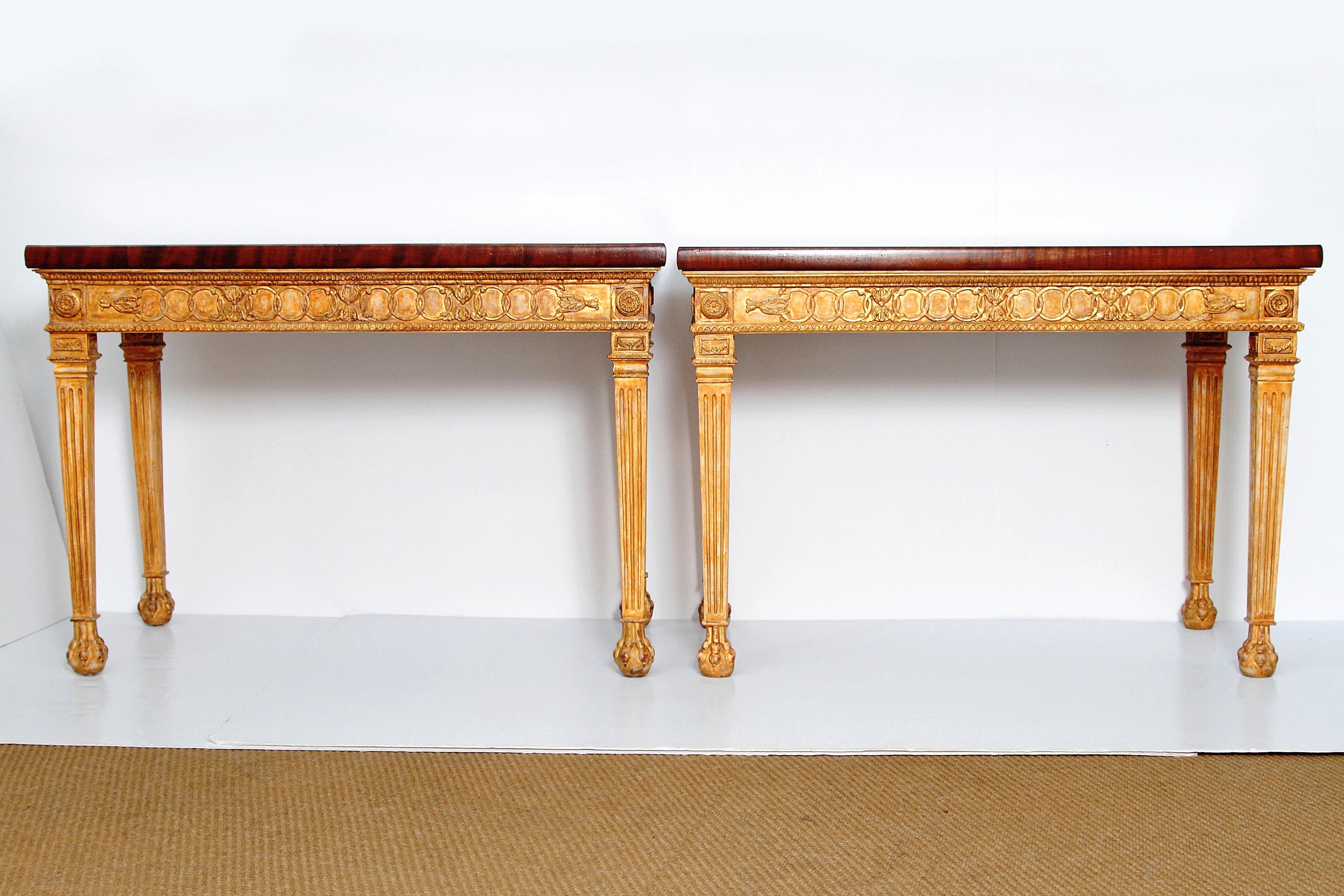 Pair of very handsome George III-style giltwood and mahogany console tables, carved and gilded base with tapered, fluted legs and ball and claw feet with beautiful mahogany table tops.