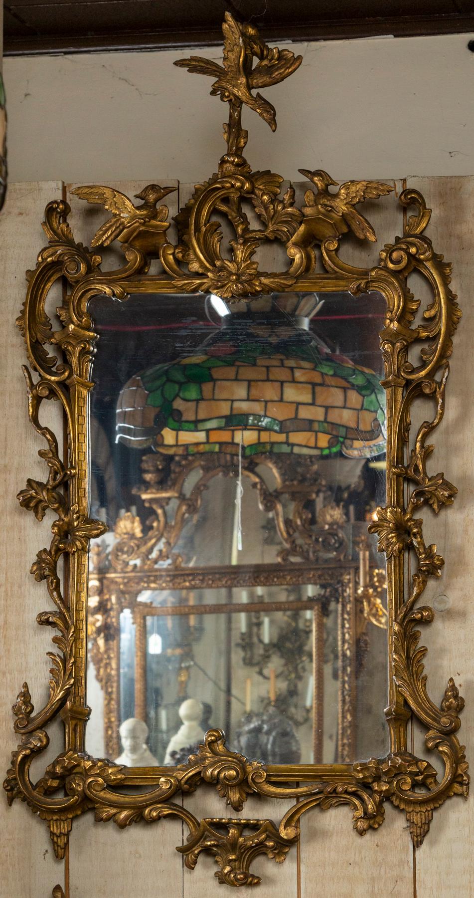 Expertly carved giltwood, topped by a spread wing phoenix about to feed her 2 fledglings. The whole surrounded with C scrolls, leaves, flowers and branches.
Possible replaced glass.

Please note that  all purchases  must  be completed  by  May 31,