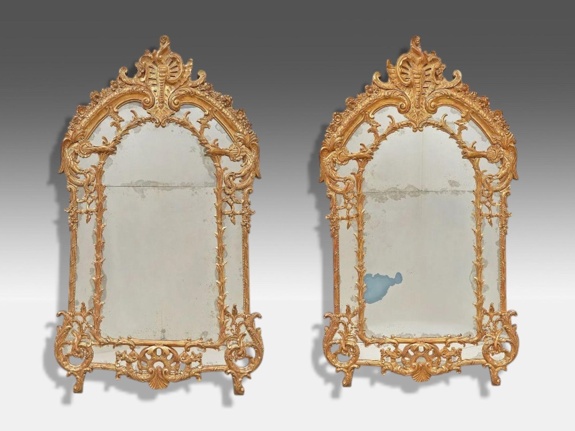 George III Style, Giltwood, Silvered Mirror, Monumental Wall Mirrors, England, 1950s

Pair of monumental George III style giltwood and silvered glass large wall mirrors produced in 20th century England. Each example features well done clayed gilt