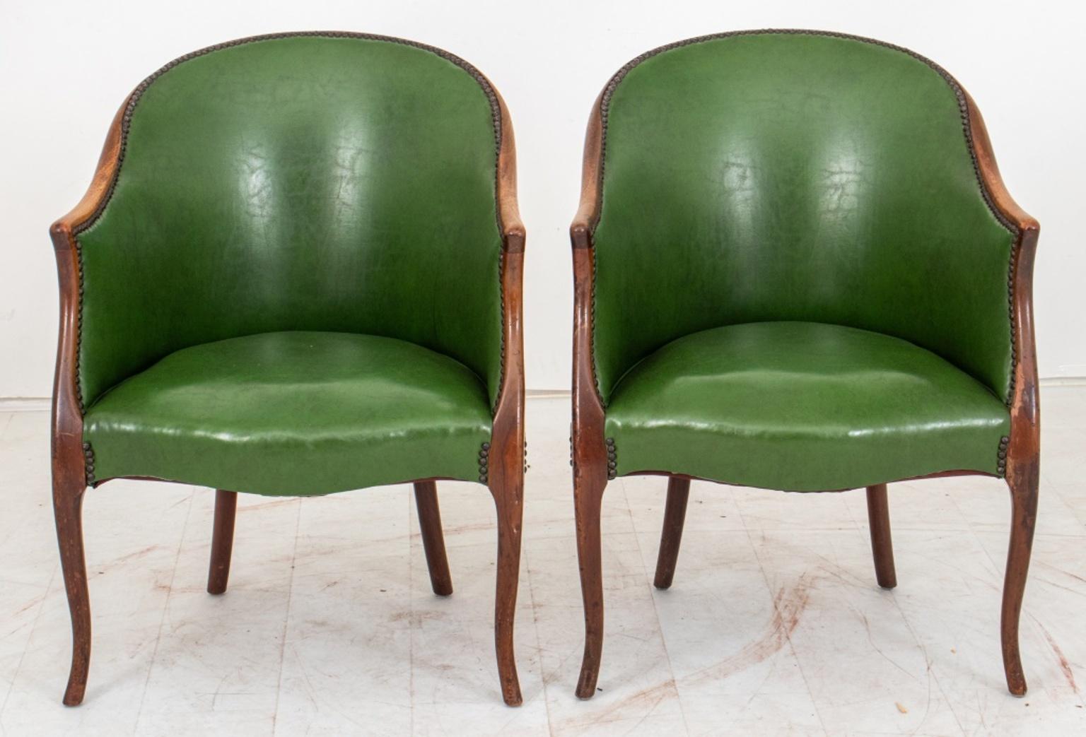 George III Style Leather Upholstered Games Chairs, each with barrel backs with nailhead-decorated green leather upholstery, down swept arms and splay feet. 

Dimensions: 33