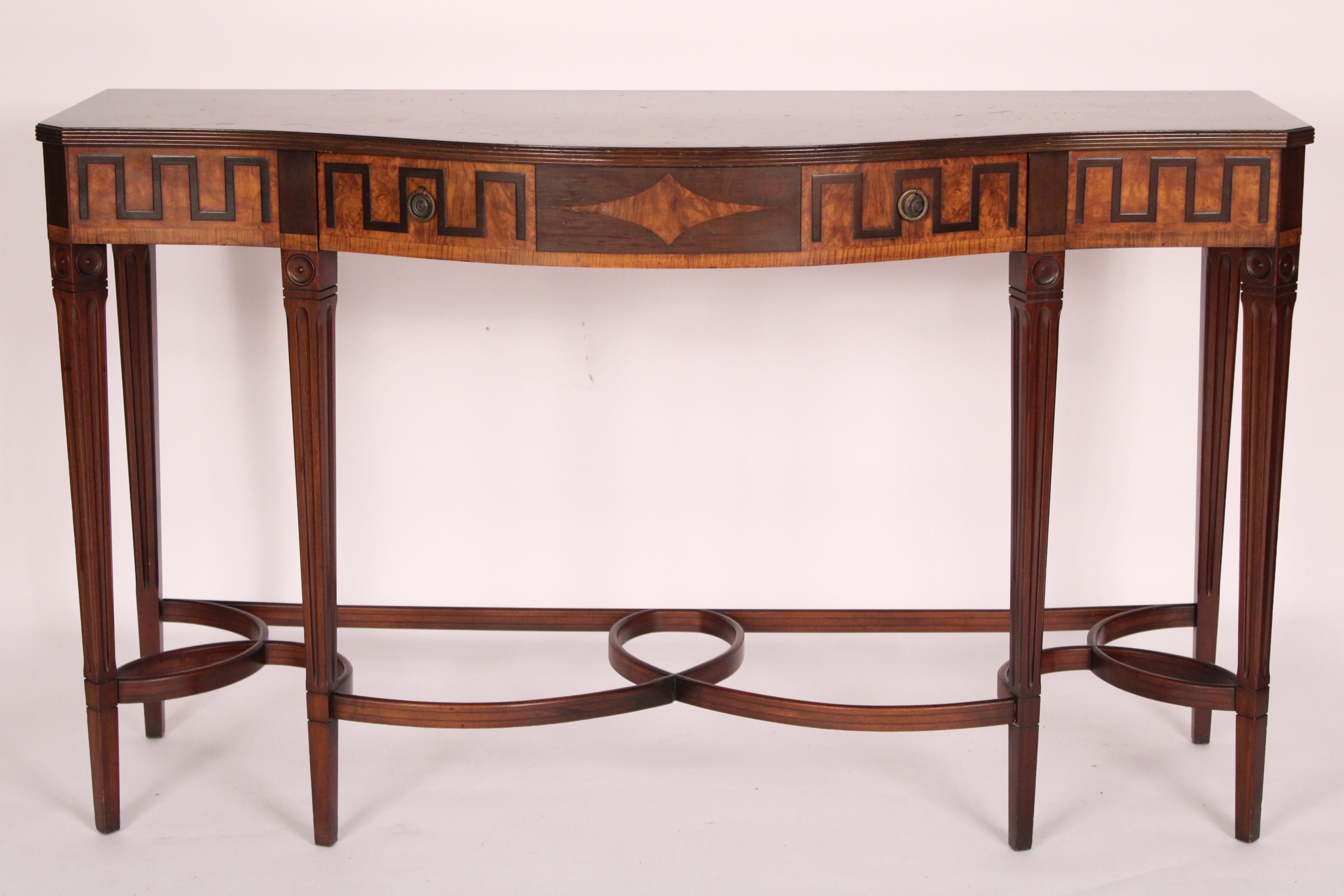 George III mahogany and burl walnut server, circa 1920's. The top with reeded moldings on front and side edges and canted corners, the frieze with a drawer with central diamond inlay flanked by stylized Greek design, resting on square tapered fluted