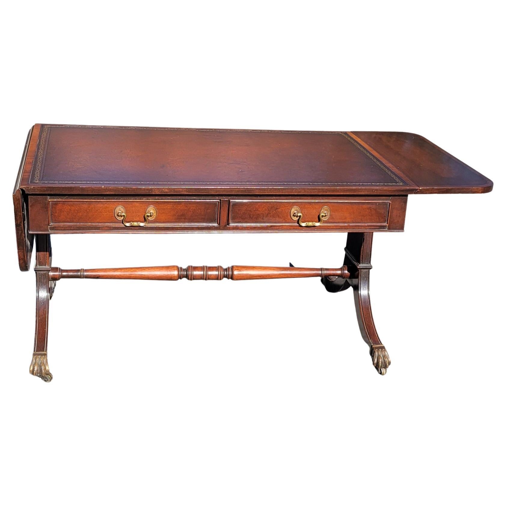 A George III style Mahogany and leather top inset drop leaf coffee table in good vintage condition. Table on original wheels. Wheel may be removed if not desired.
Measures 46.25