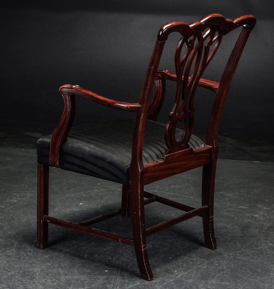 Fauteuil en acajou de style George III, tapissé d'une couverture noire rayée. 1900. Traces d'usure.