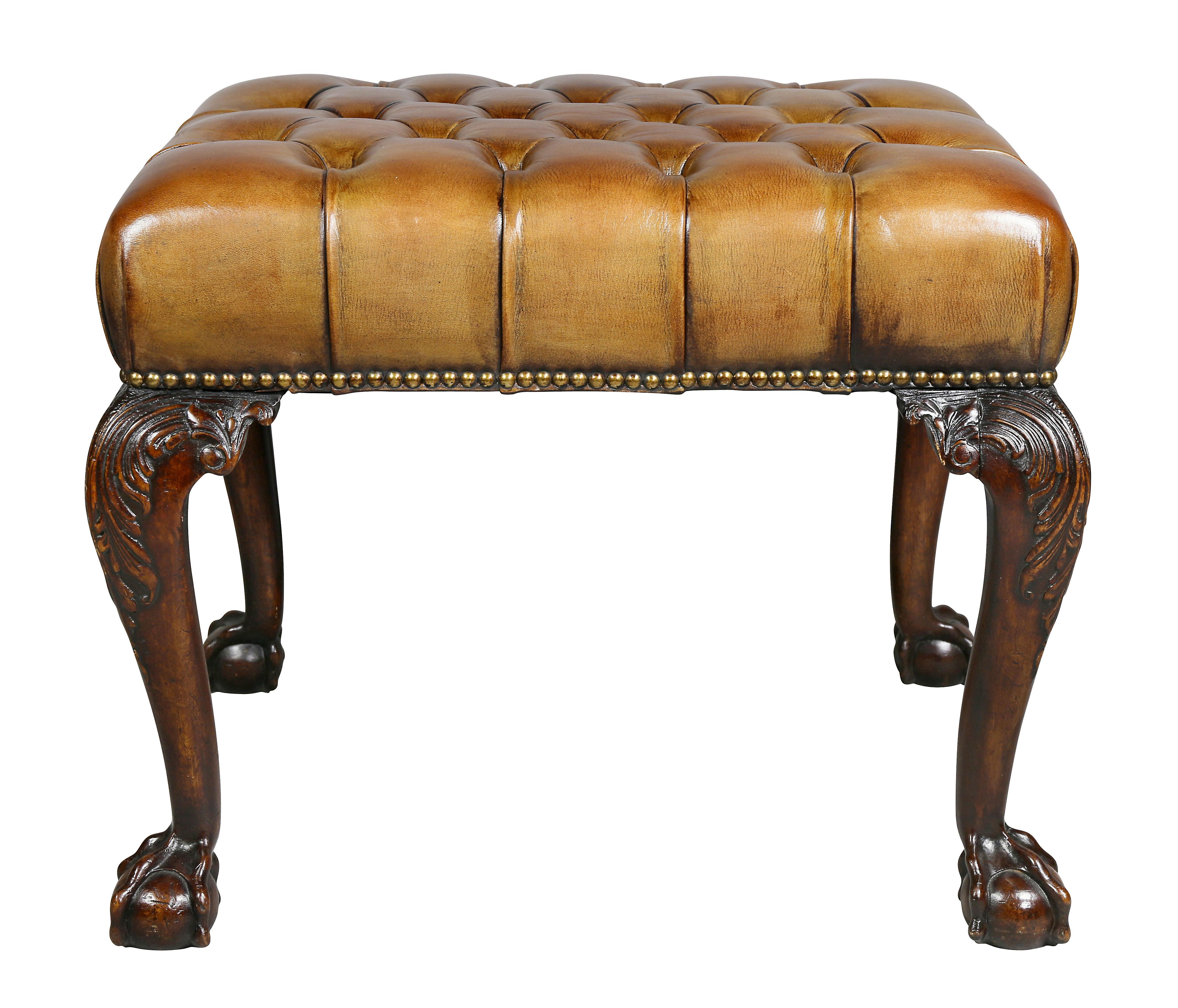 Rectangular with tufted brown leather seat, carved cabriole legs ending on ball and claw feet. Collection W. Hodgins.