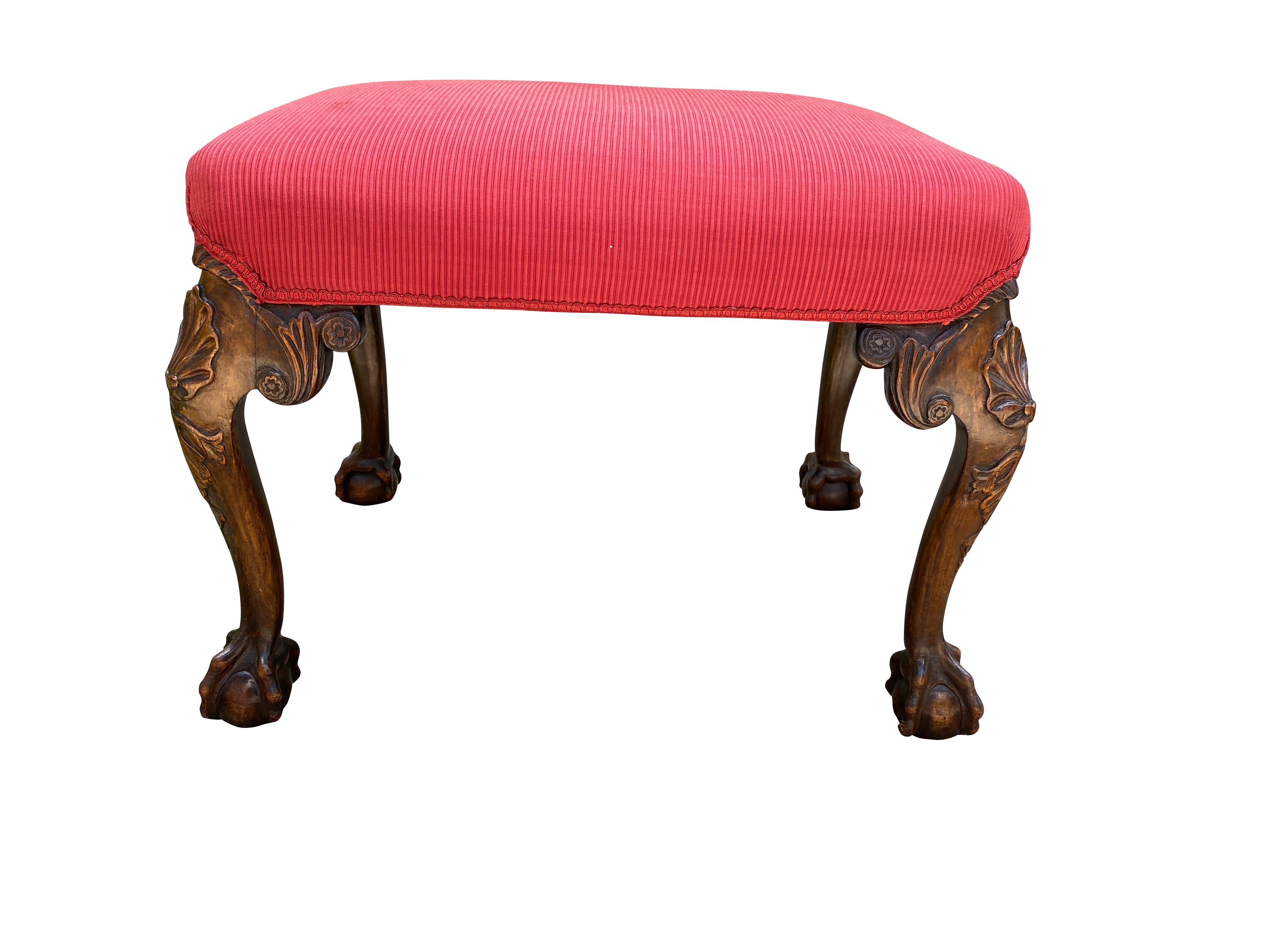 Rectangular upholstered seat with carved cabriole legs with shell carved knees and ball and claw feet.