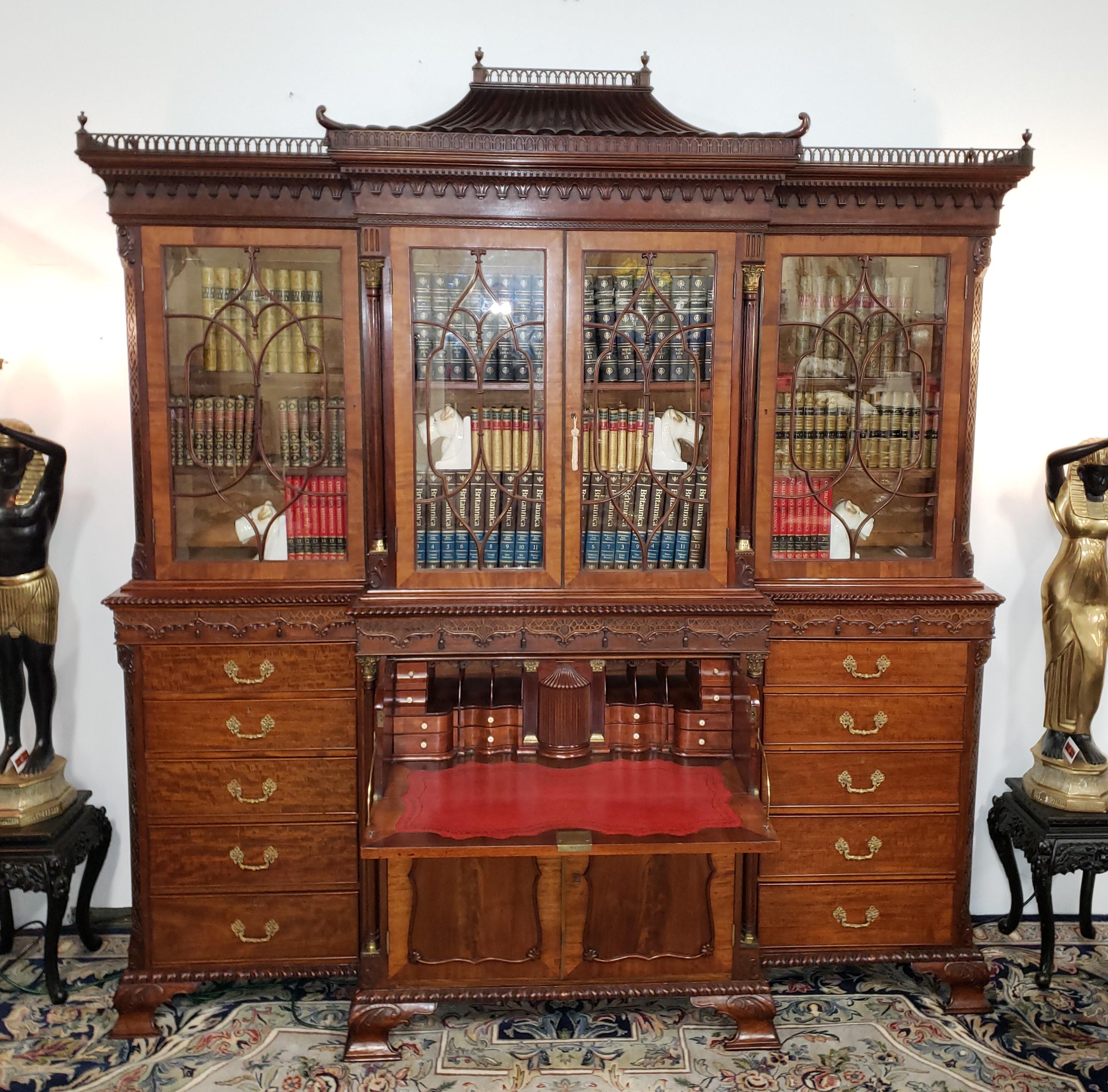 George III style mahogany breakfront Secretaire library bookcase by Earnest William Varley, circa 1913. A most important piece created in the Chinese Chippendale style, displaying a pagoda cresting with pierced fretwork gallery featuring urn