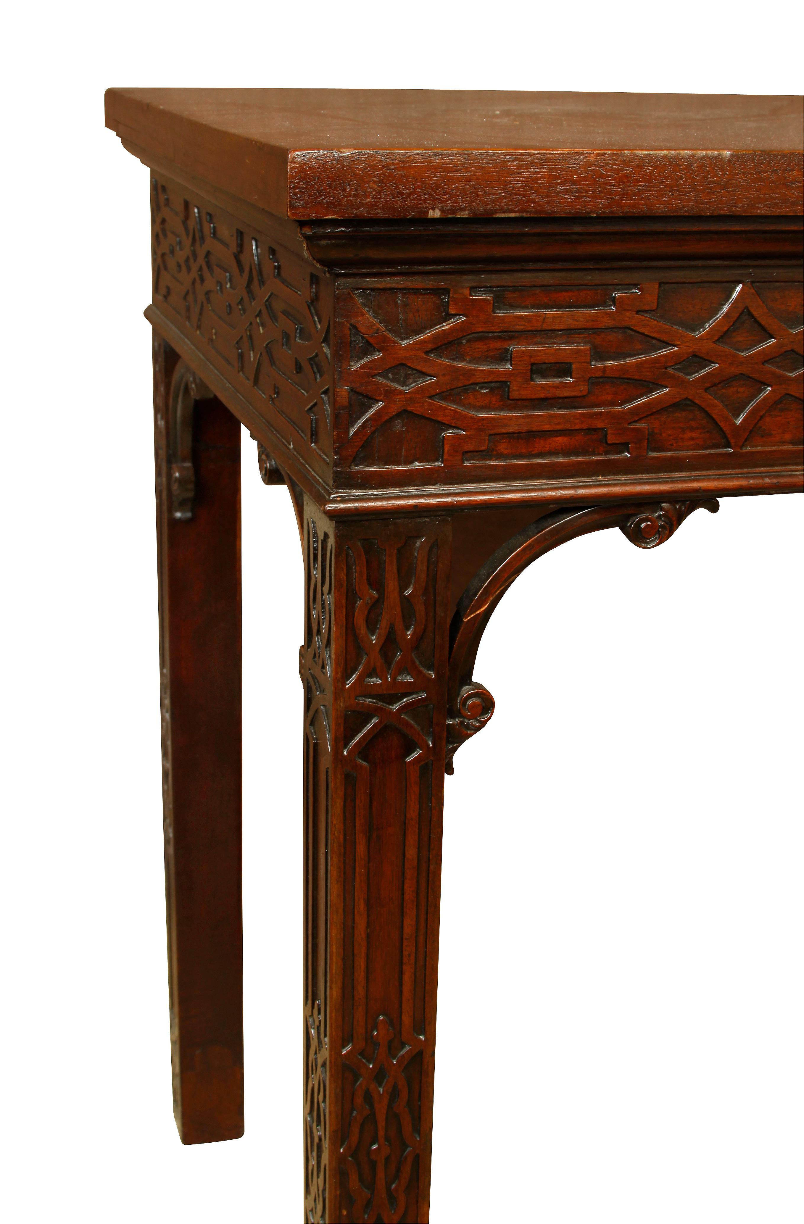 George III style mahogany console table. Carved design on apron and legs.