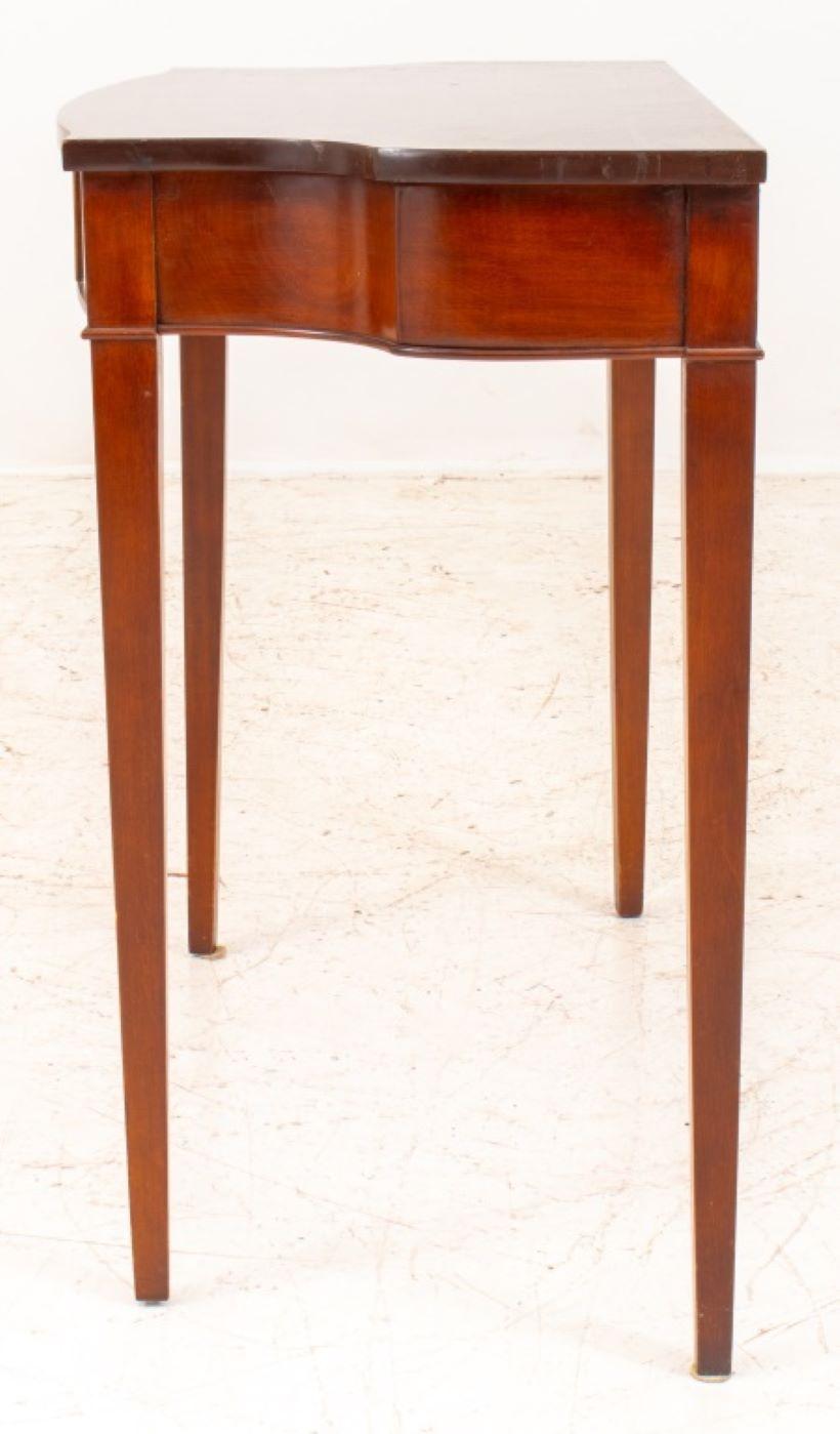 George III Style mahogany console table, apron enhanced with neoclassical marquetry motifs, raised on square tapered legs.

Dealer: S138XX