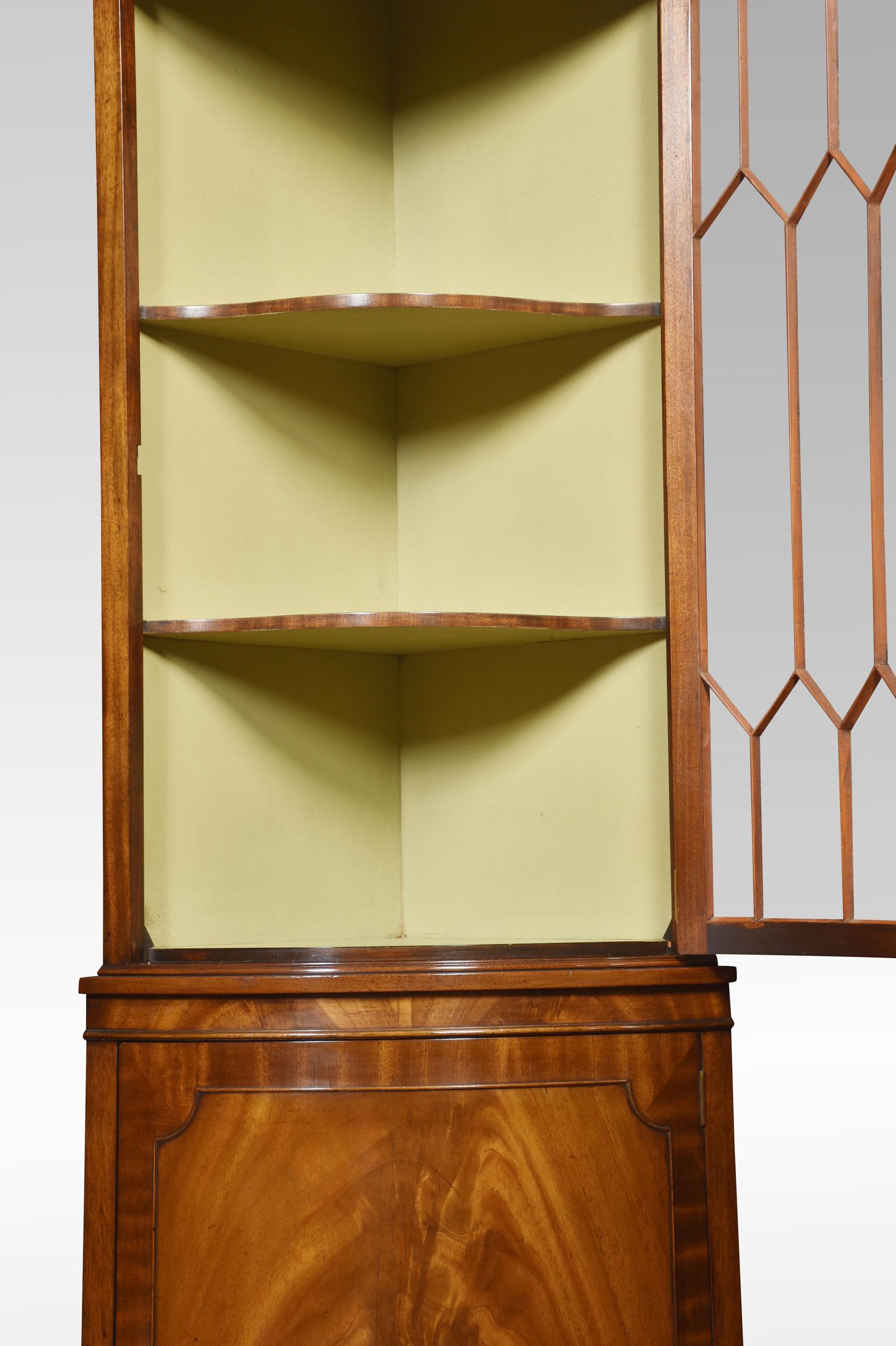 Mahogany standing corner cupboard, the bow-fronted astragal glazed doors opening to reveal two fixed shelves above a bow fronded flame mahogany panelled door, raised up on shaped bracket feet.
Dimensions
Height 75 Inches
Width 26 Inches
Depth 18