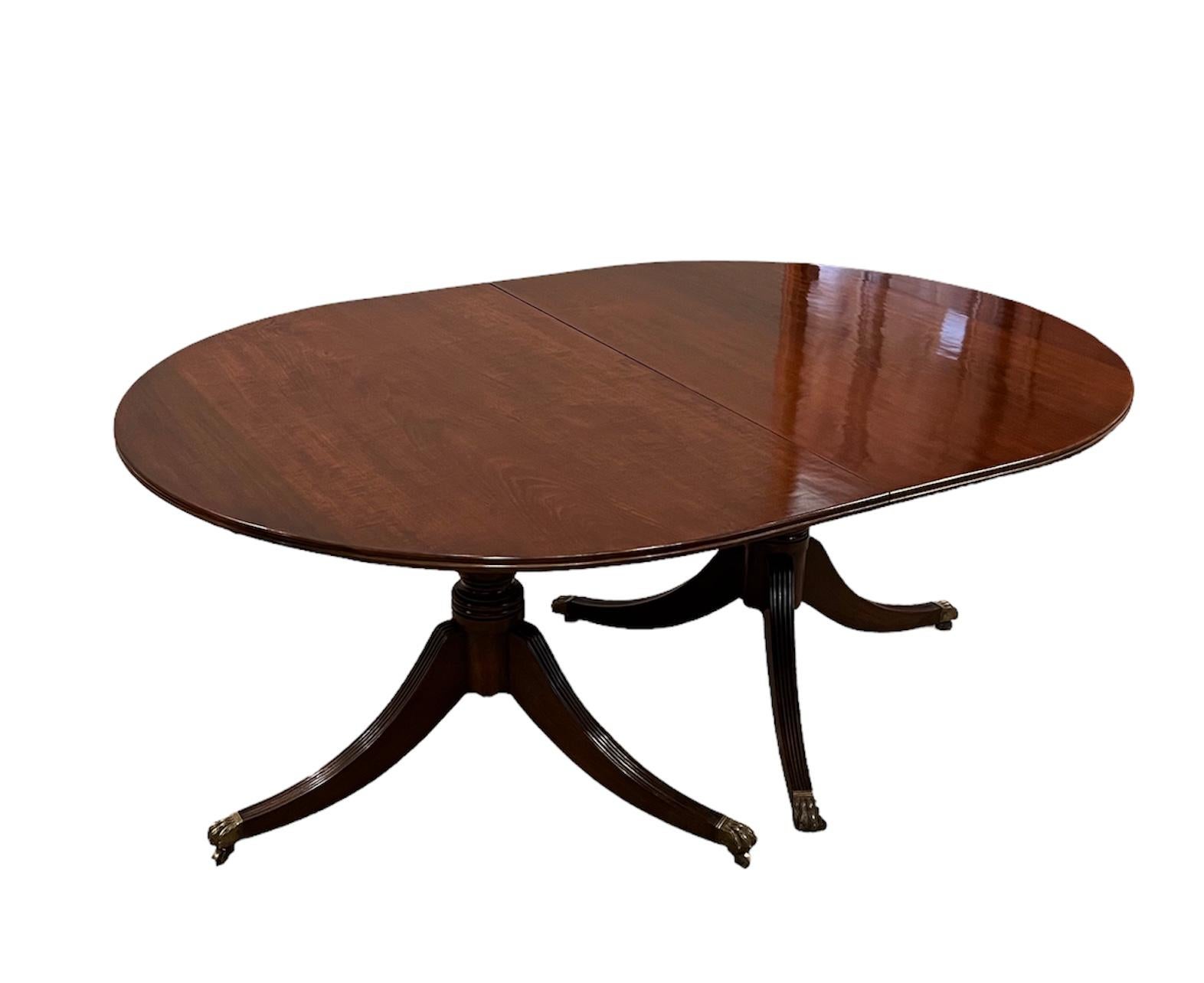 This lovely George III Style 2 pedestals Mahogany Dining Table with 
2 leaves 6 clips.  Table was tightn& polished. In easy to use condition. 
Each leaf adds 12 inches. Total length 96 inches 