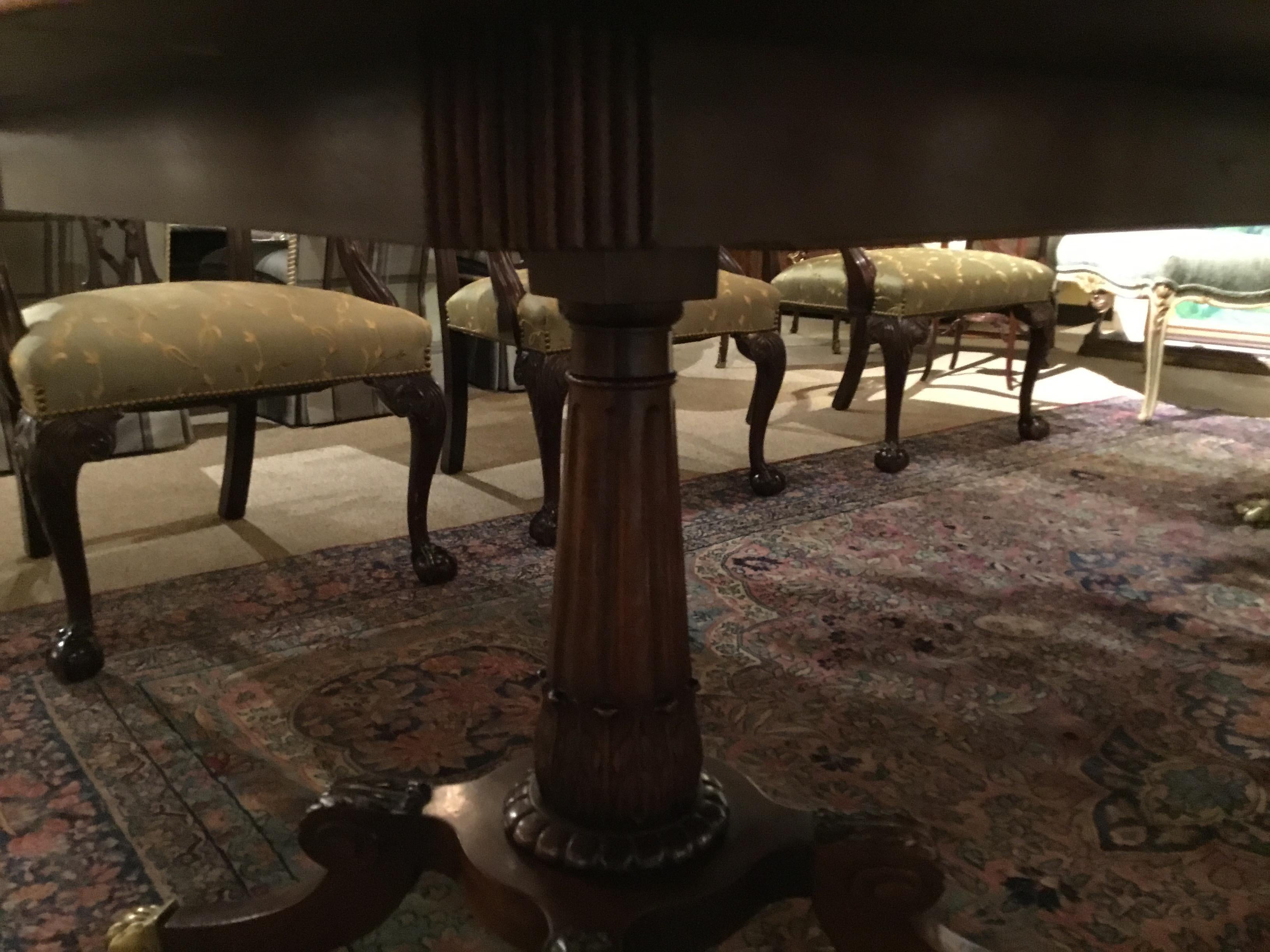 Early 20th century of very fine quality mahogany with satin wood and ebony banding.
The table is raised on two pedestals, each with a fluted graduated standard to a platform
Raised on four scroll- capped splayed legs ending in brass paws on