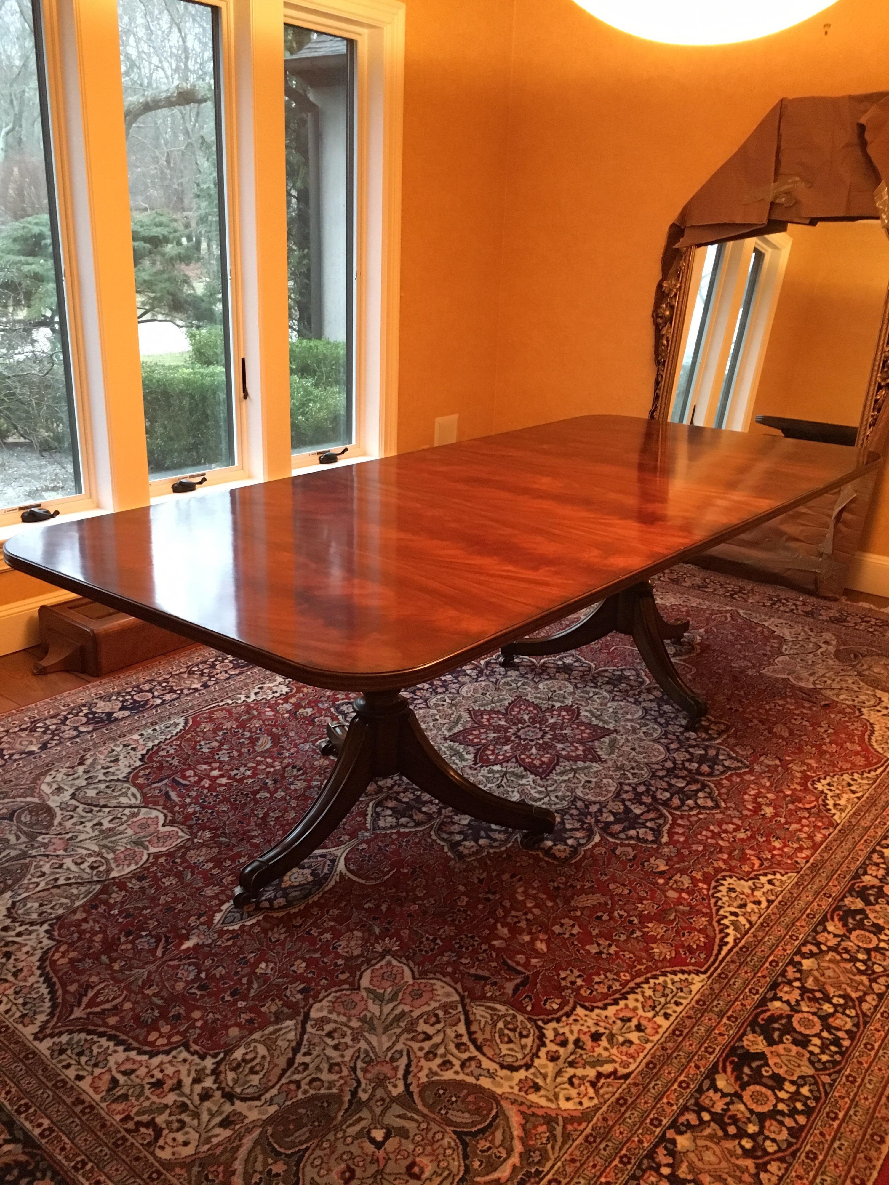 George III style mahogany double pedestal dining table by Maitland-Smith. 1960s. On casters. Two small areas of discoloration on the tabletop. Light wear to edges. 
120