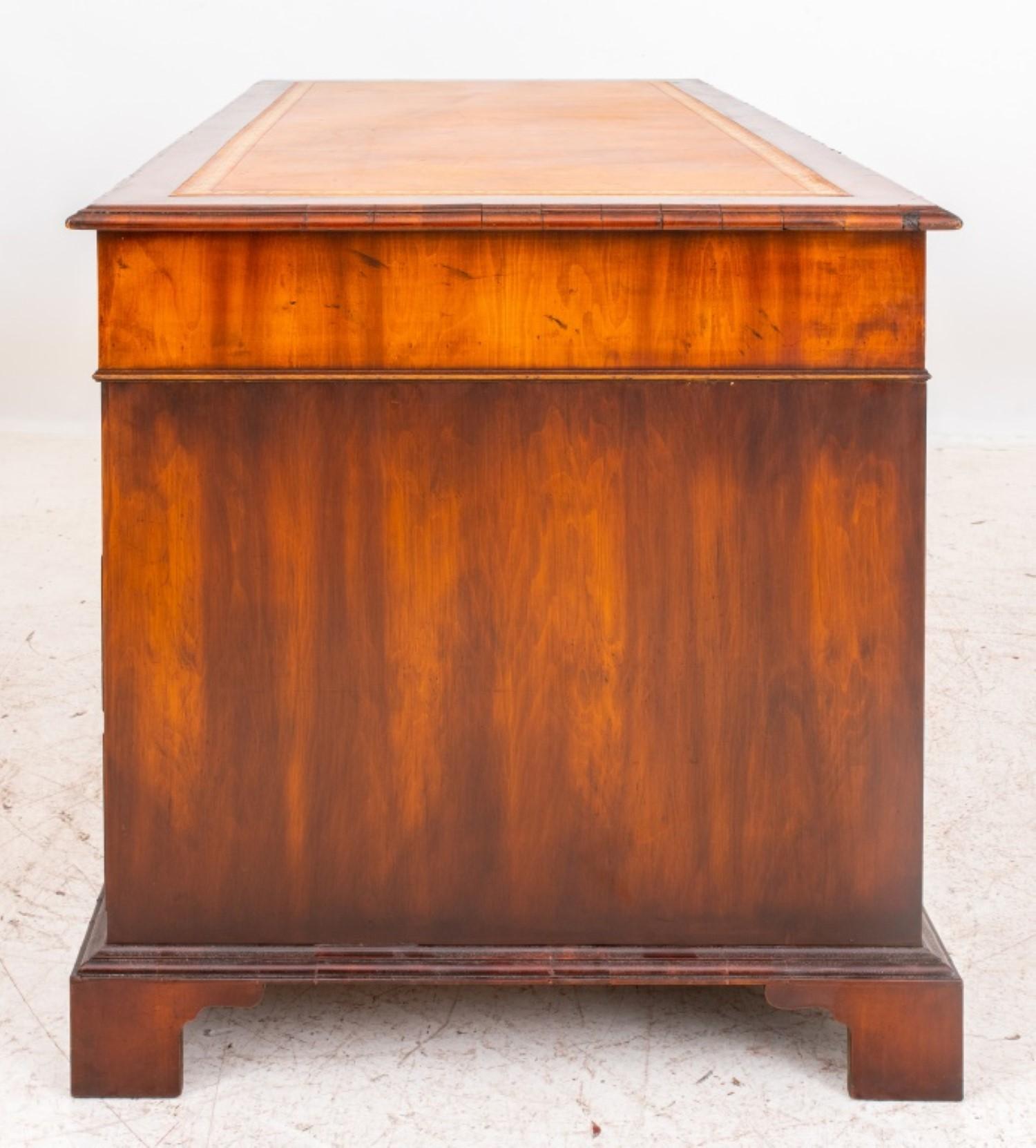 George III style mahogany veneered desk, rectangular with three short drawers above two pedestals, each with three drawers on plinths with bracket feet.

30 inches in height, 65 inches in width, and 30 inches in depth.