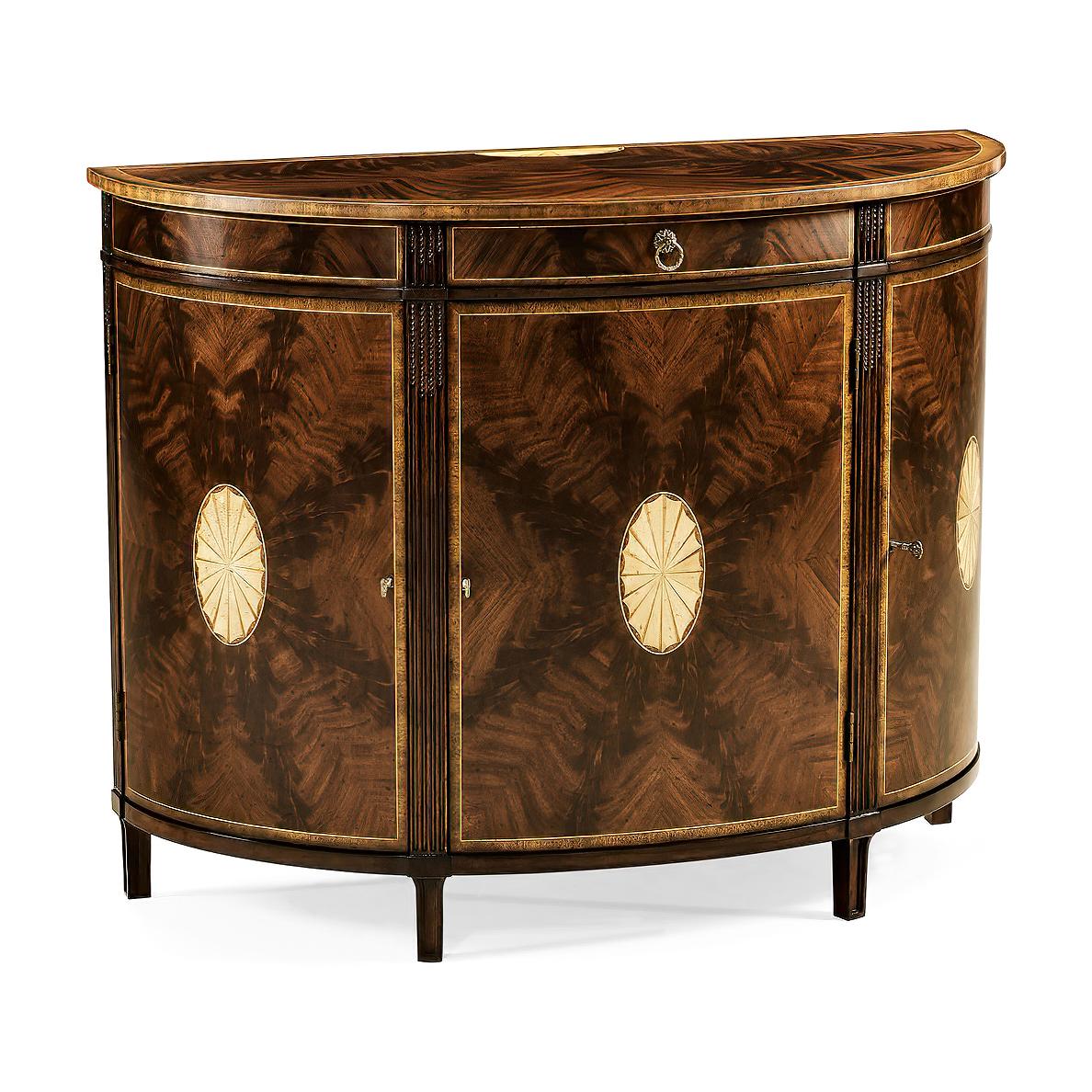 Georgian style crotch mahogany veneered demilune sideboard with contrasting marquetry fan inlays to the top and cupboard doors. With carved stop fluted details, three doors and one drawer with oak secondary woods, an adjustable shelf within and