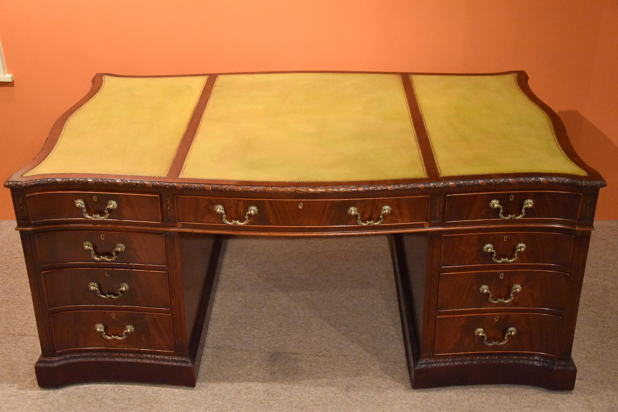 George III style mahogany serpentine partners desk a rare and impressive large mahogany serpentine shaped pedestal partners desk in the manner of Thomas Chippendale. The recently triple panel light green leather inset top sits above an arrangement