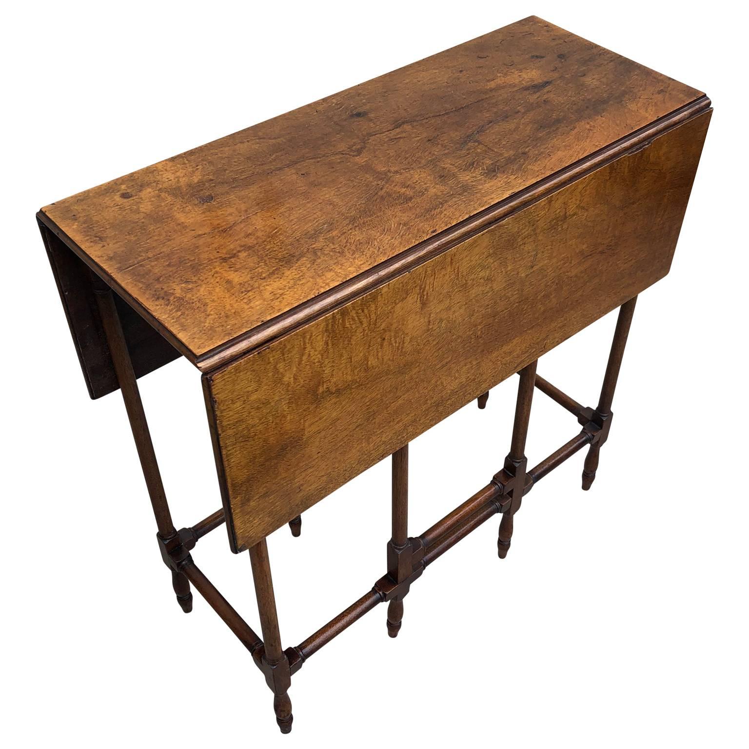 George III Style mahogany spider leg table

Georgian spider leg table with a rectangular top with two drop leaves that are supported by slender turned gate legs and are joined by carved and turned stretchers. Veneer has a beautiful glow, patina and