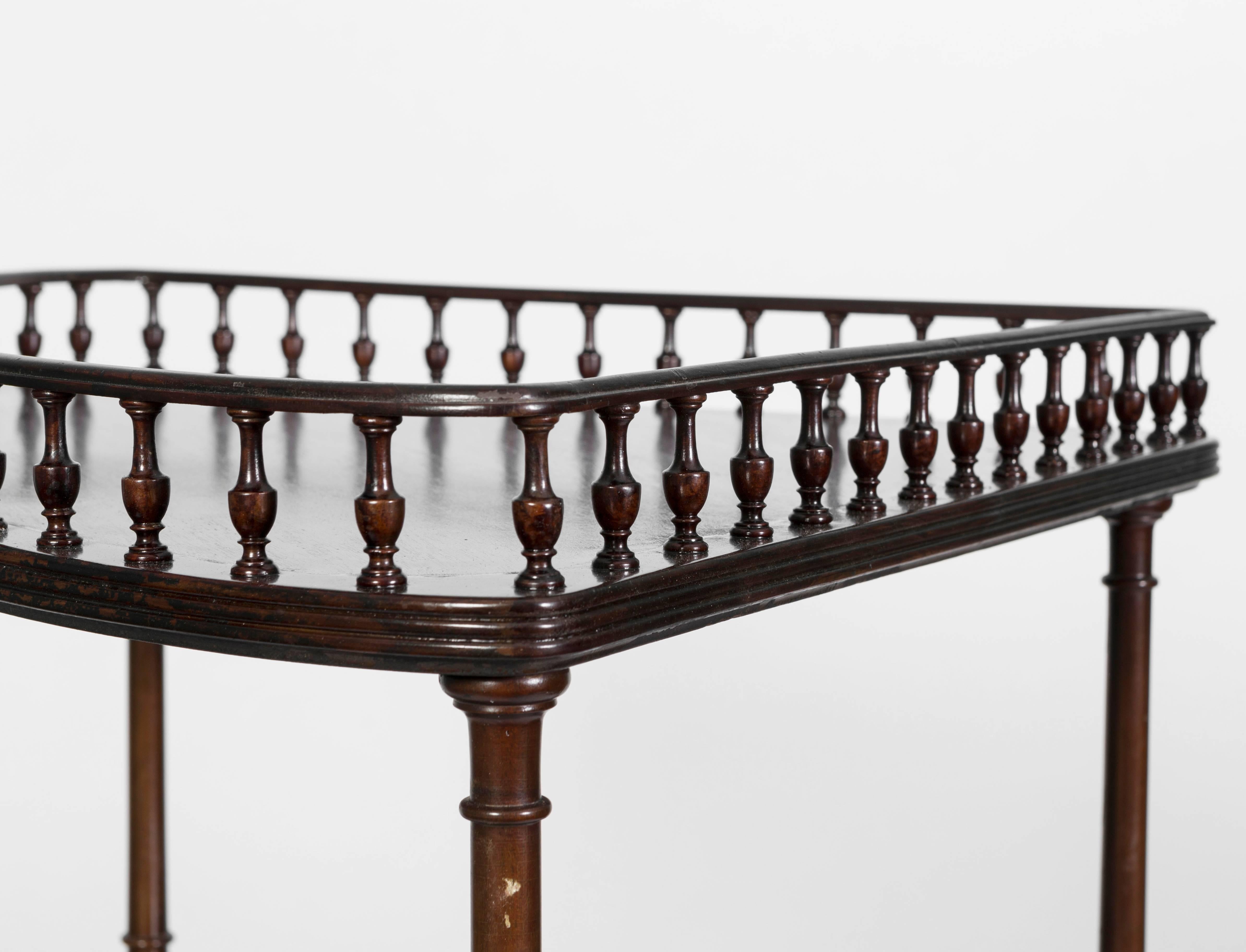 George III style mahogany three-tiered corner stand. The stand has a gallery rail on the top shelf . The corner piece makes for a perfect stand for bar accessories or a great shelf for a corner piece in the bath. This piece is both beautiful and